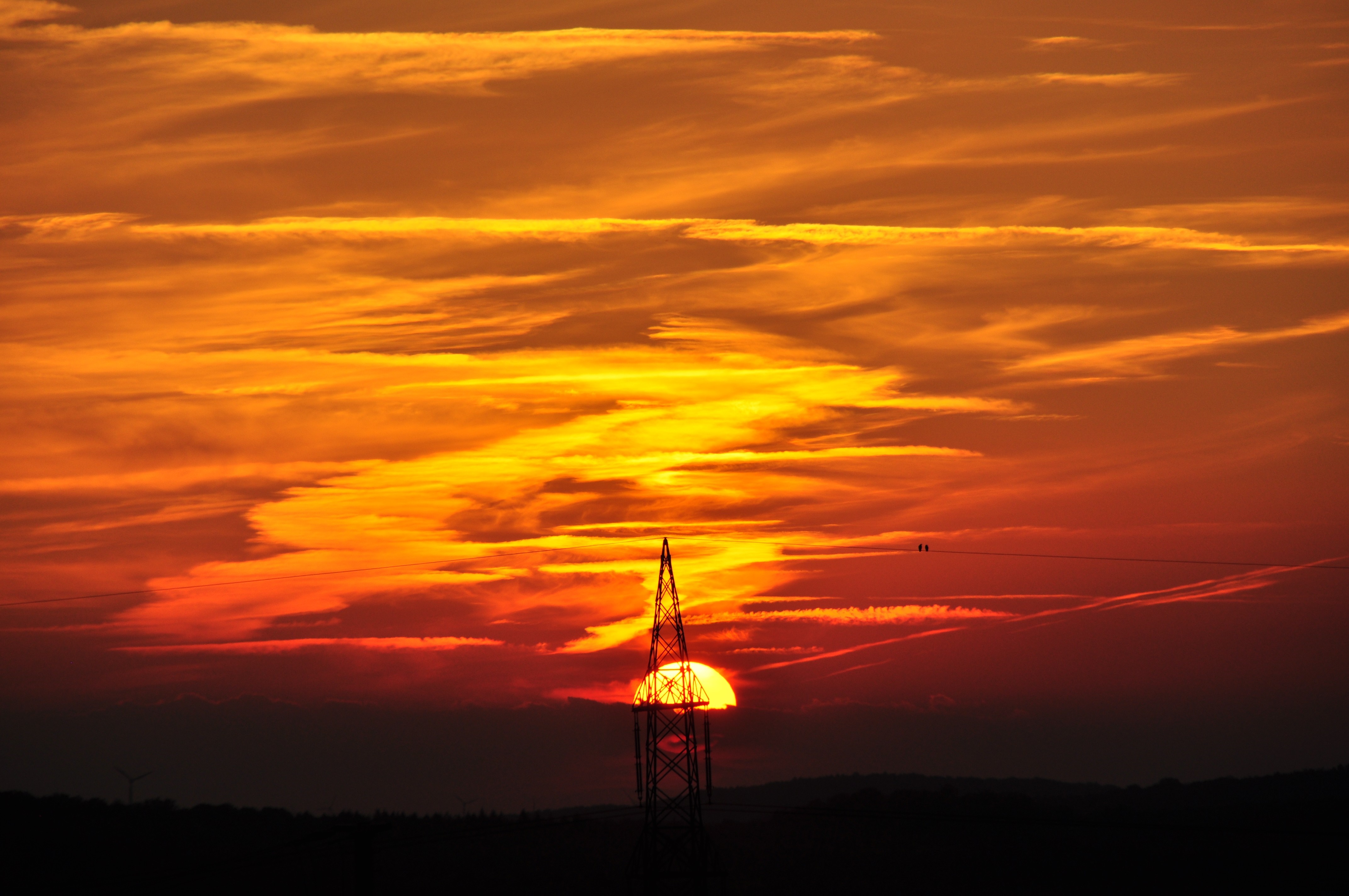 Sunset behind a power line tower with birds on a wire HD Wallpaper