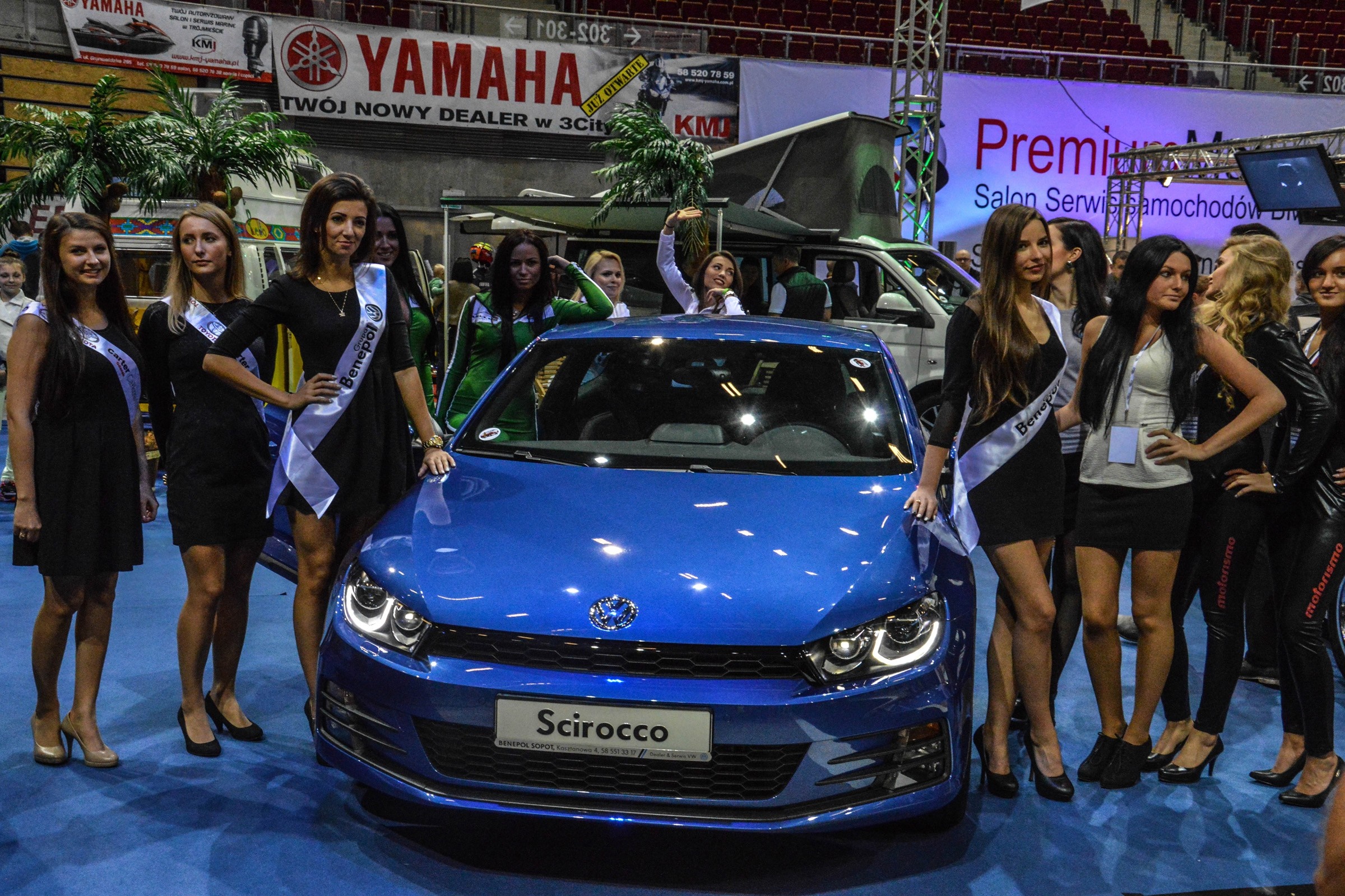 Volkswagen Scirocco with promotional models at an exhibition HD Wallpaper