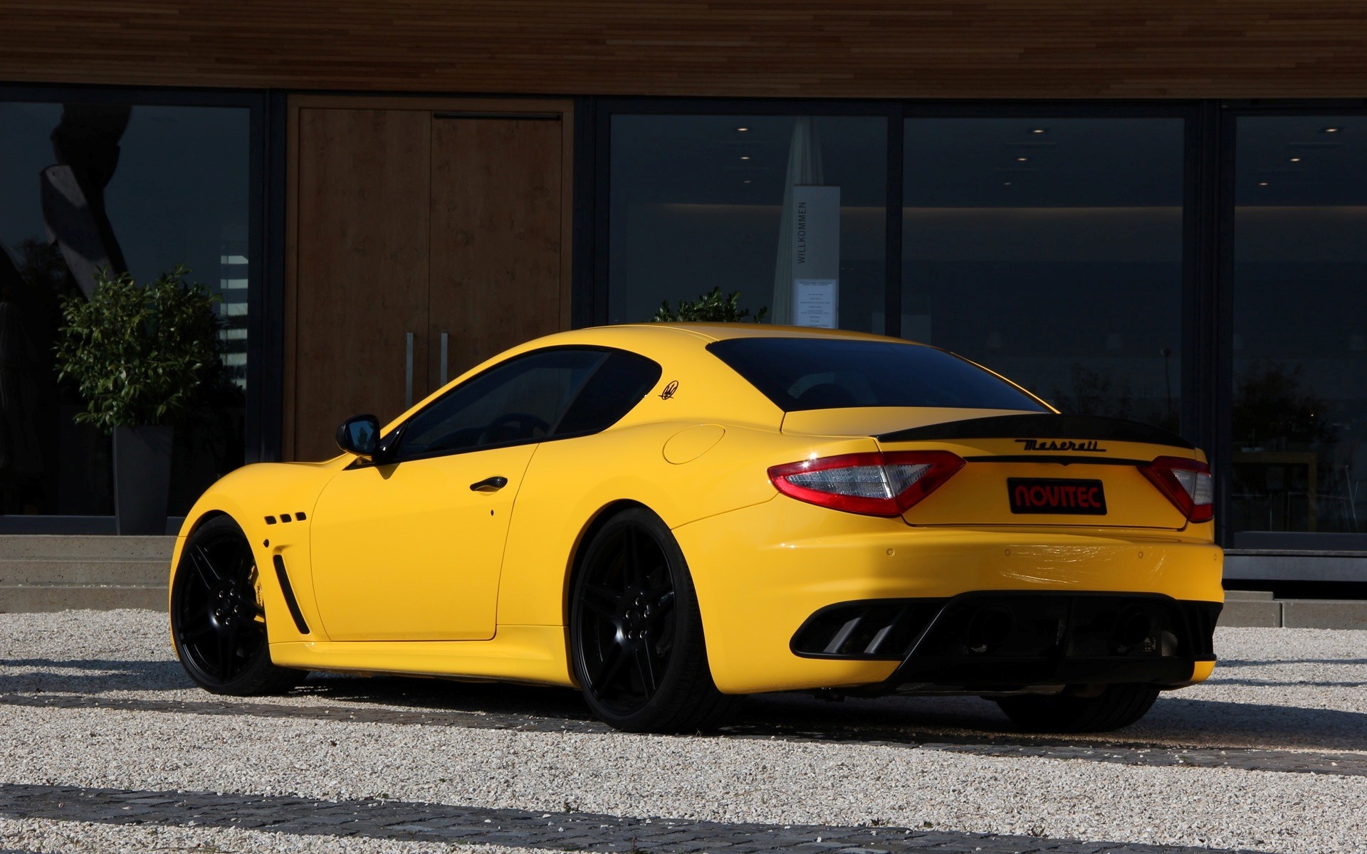 Yellow Maserati GranTurismo Novitec parked on gravel HD Wallpaper