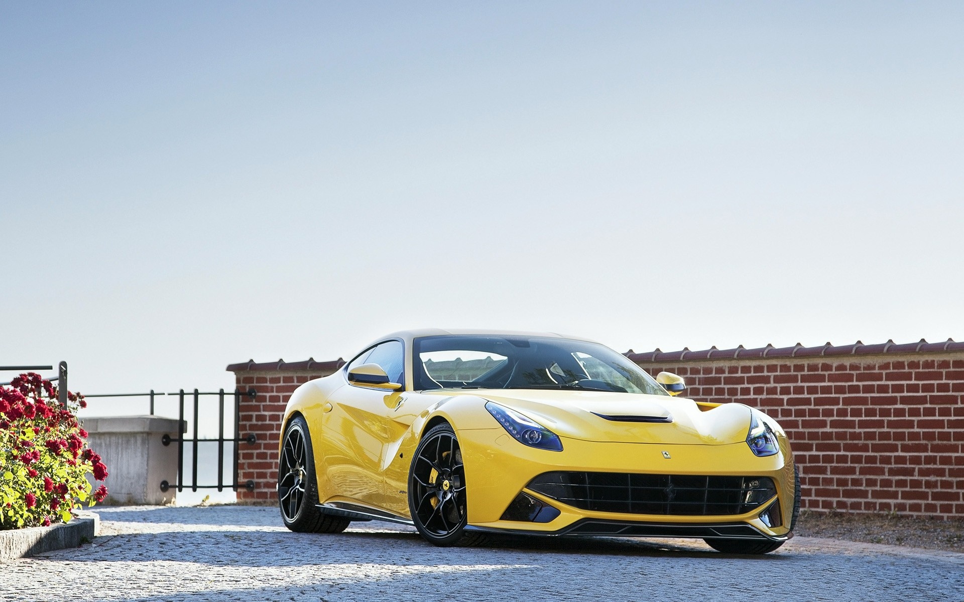 Yellow Ferrari F12berlinetta parked outdoors HD Wallpaper