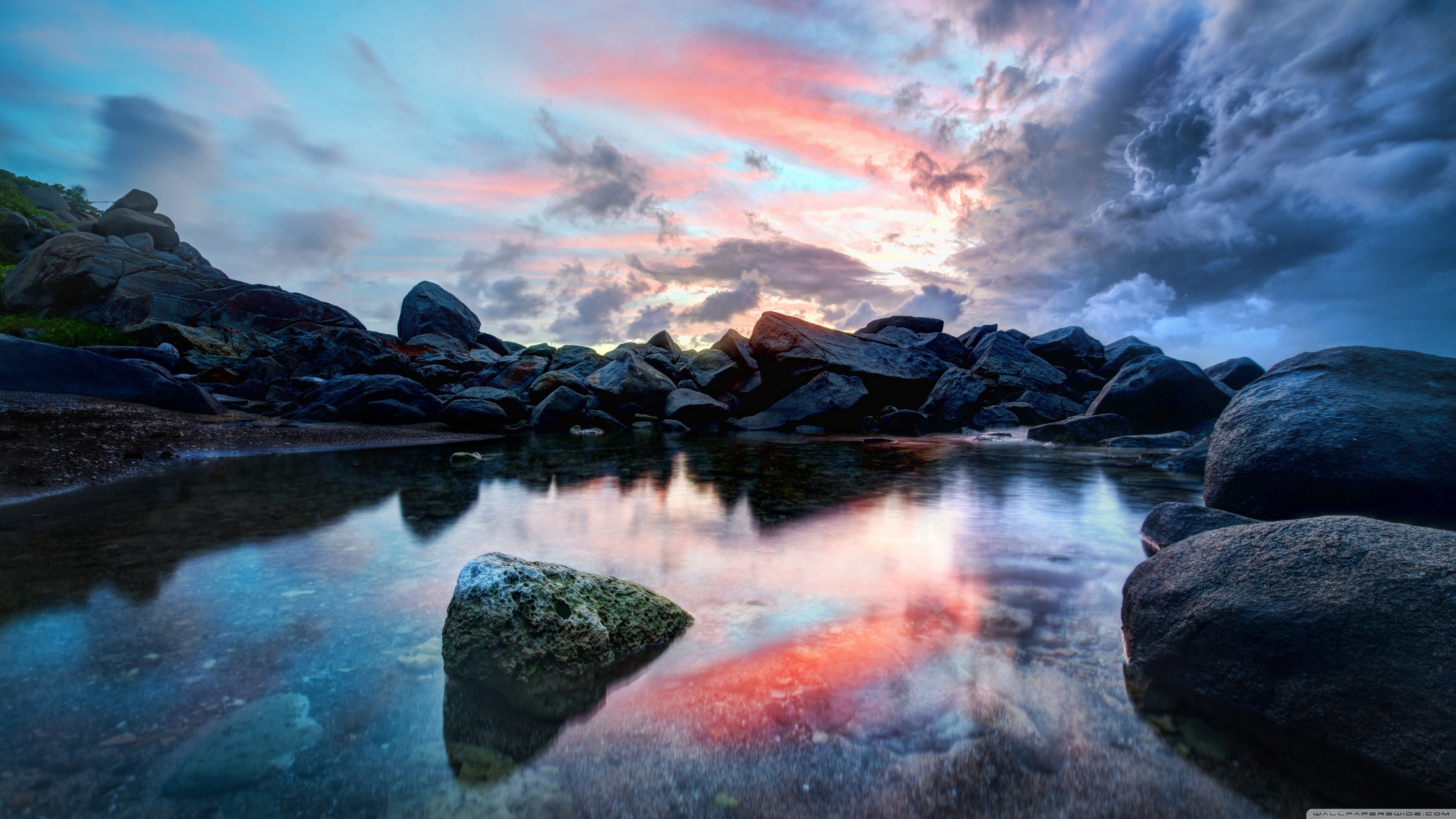 Rocky coast with colorful sunset reflection on water HD Wallpaper