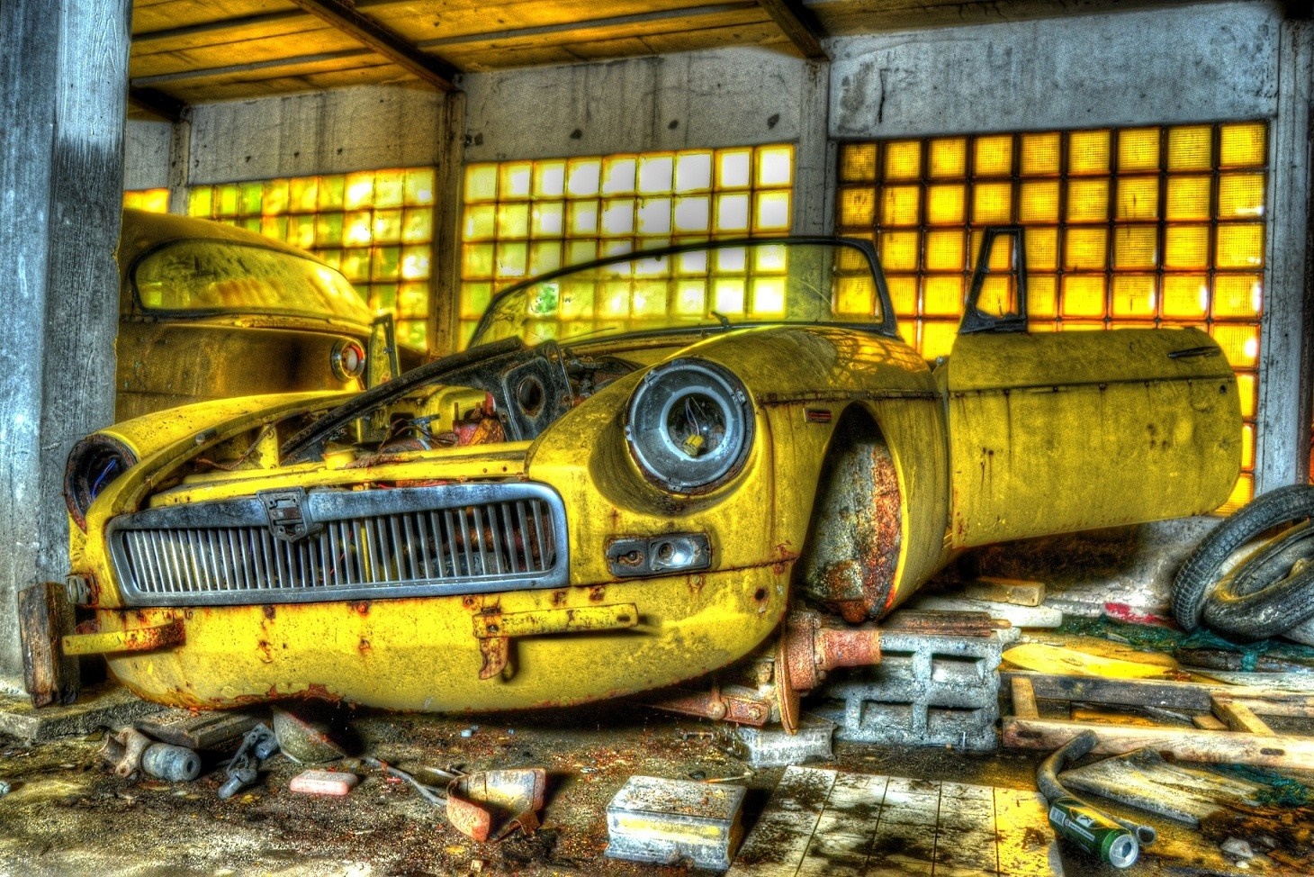 Abandoned yellow vintage car in a derelict garage HD Wallpaper