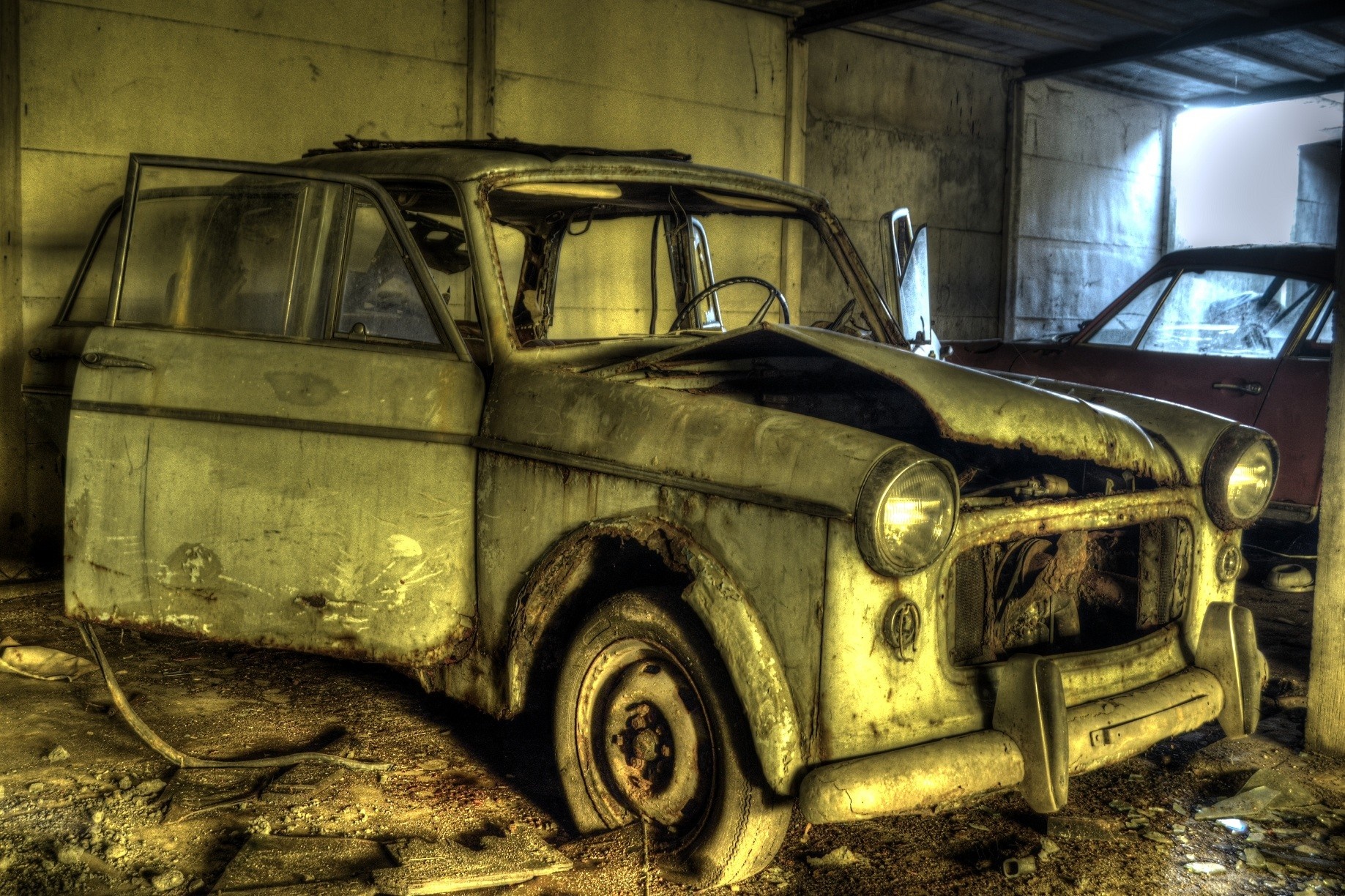 Abandoned vintage car in a derelict garage HD Wallpaper