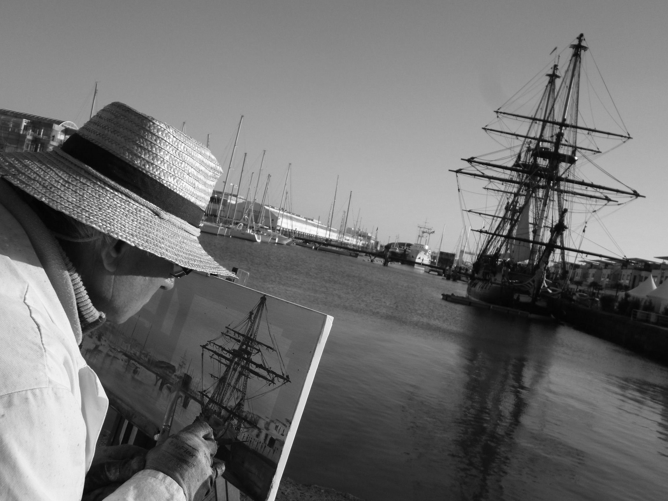 Artist painting a tall ship in a harbor HD Wallpaper