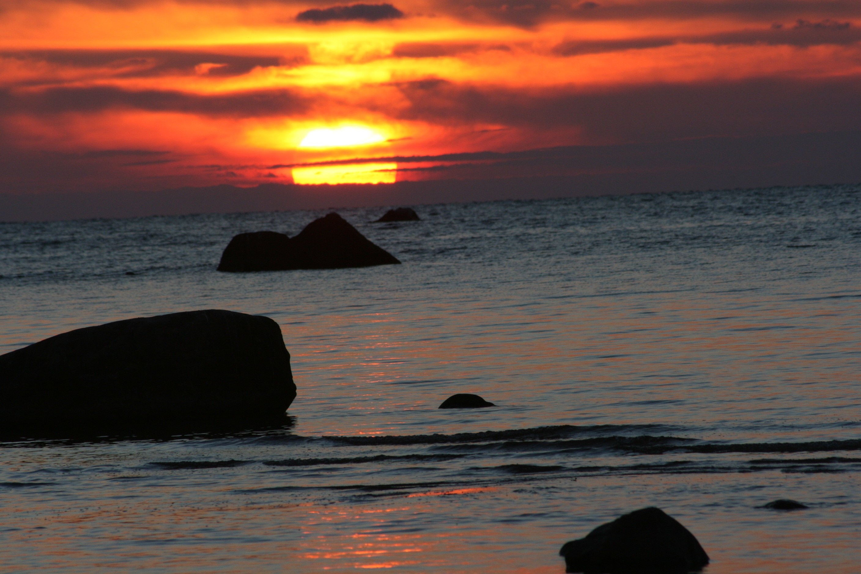 Sunset over the sea with rocks HD Wallpaper