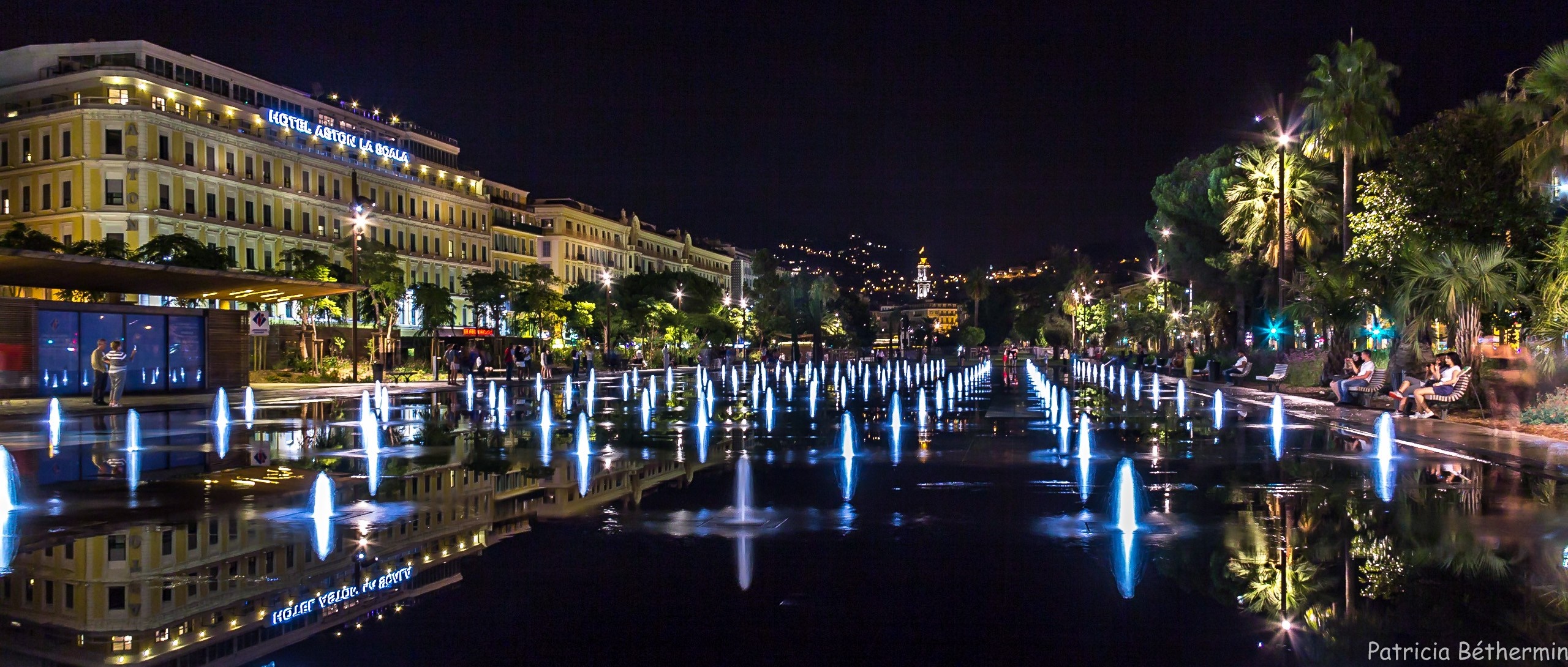 Night view of Promenade du Paillon fountains and Hotel Aston La Scala HD Wallpaper