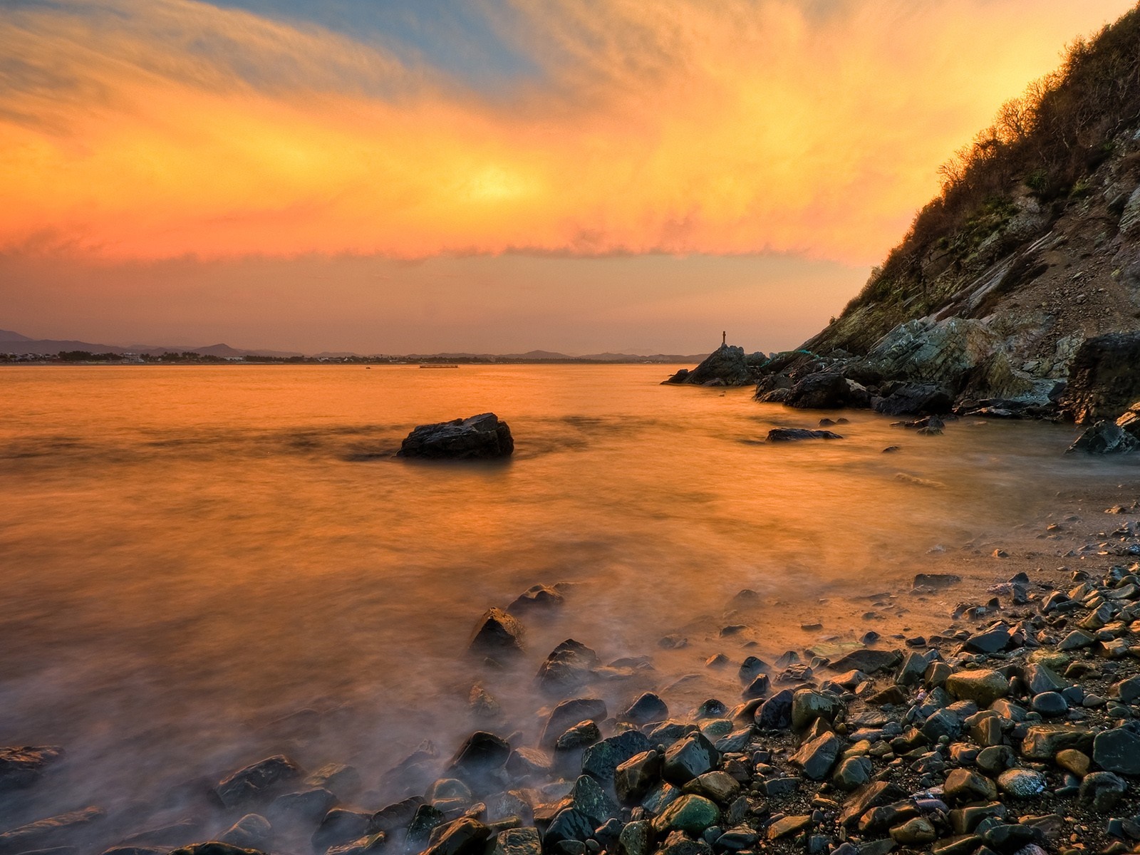 Sunset over the sea with rocky shore HD Wallpaper
