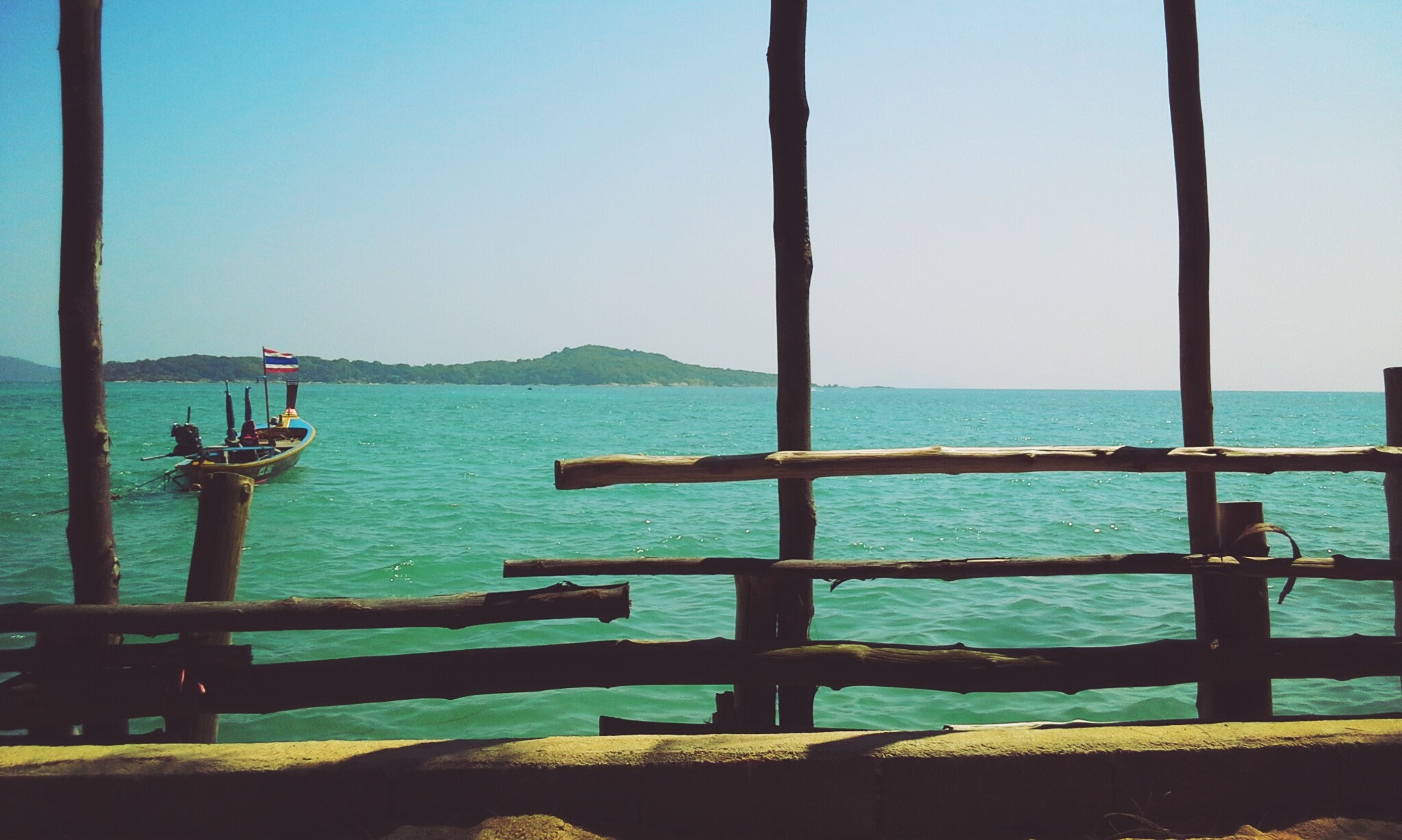 Boat with Thai flag on turquoise water near island HD Wallpaper
