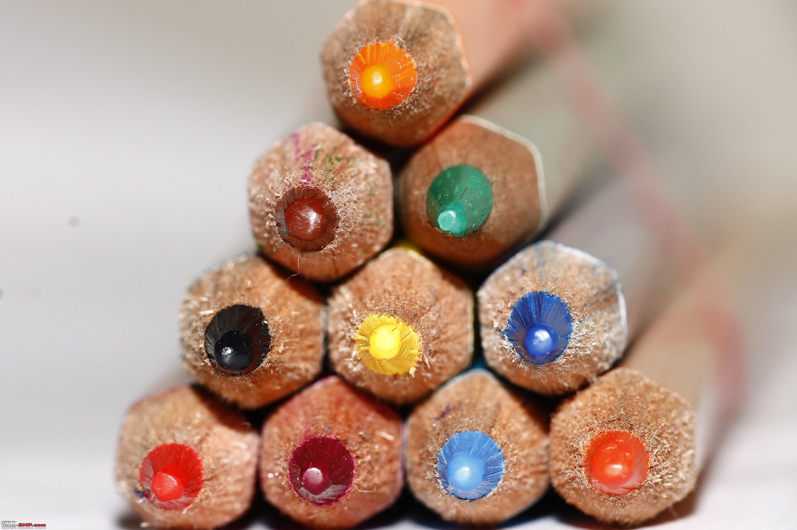 Close-up of colored pencil tips stacked in a pyramid HD Wallpaper