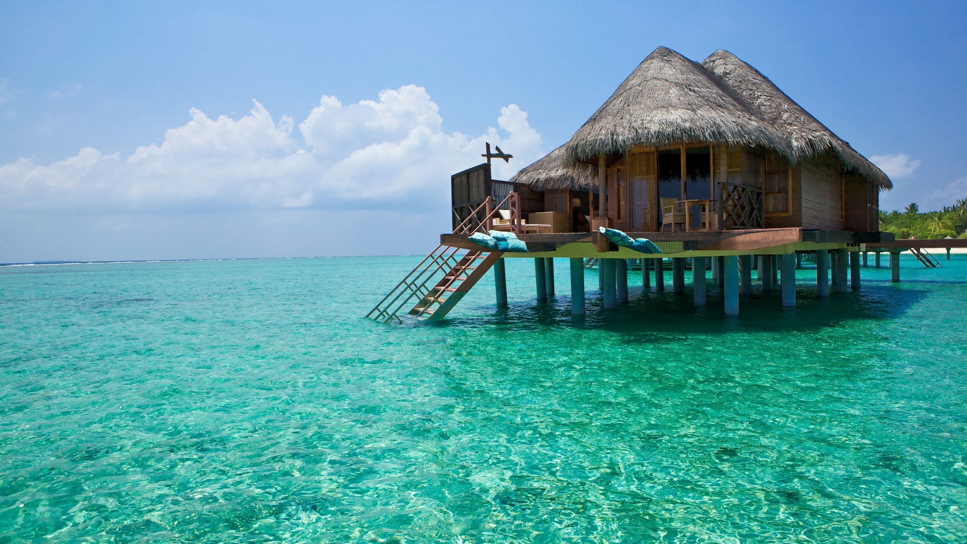 Overwater bungalow in turquoise ocean HD Wallpaper