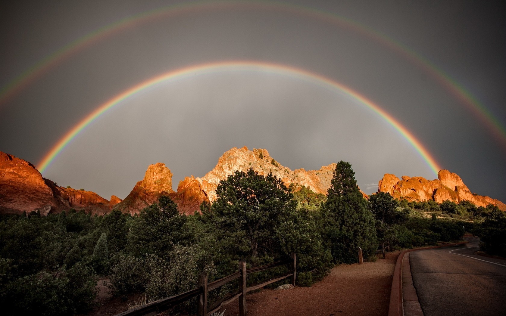 Double rainbow over red rock formations and trees HD Wallpaper
