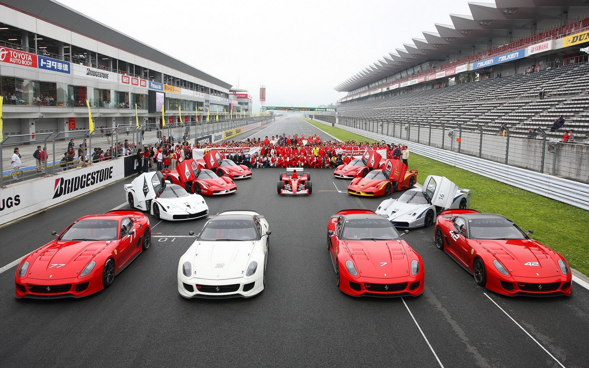 Ferrari cars and drivers on a race track HD Wallpaper