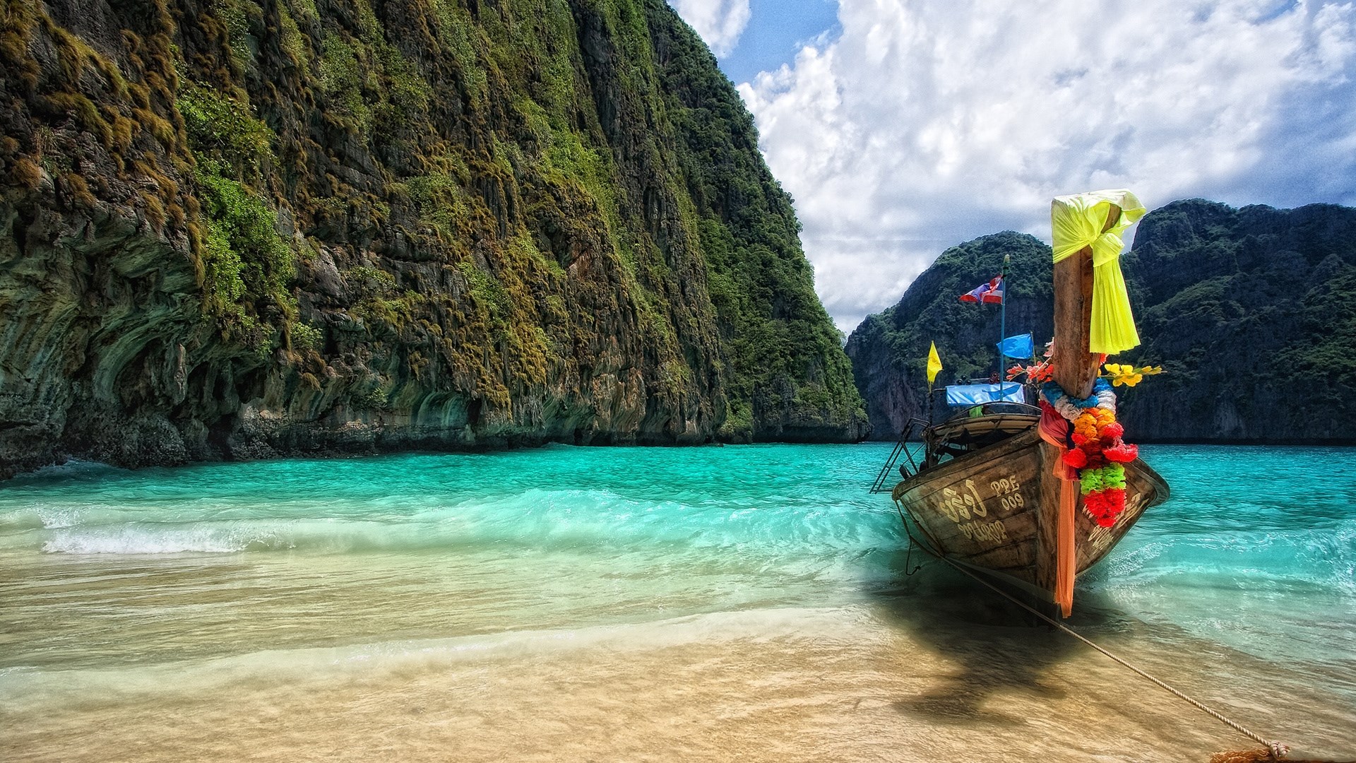 Longtail boat on a tropical beach with limestone cliffs HD Wallpaper