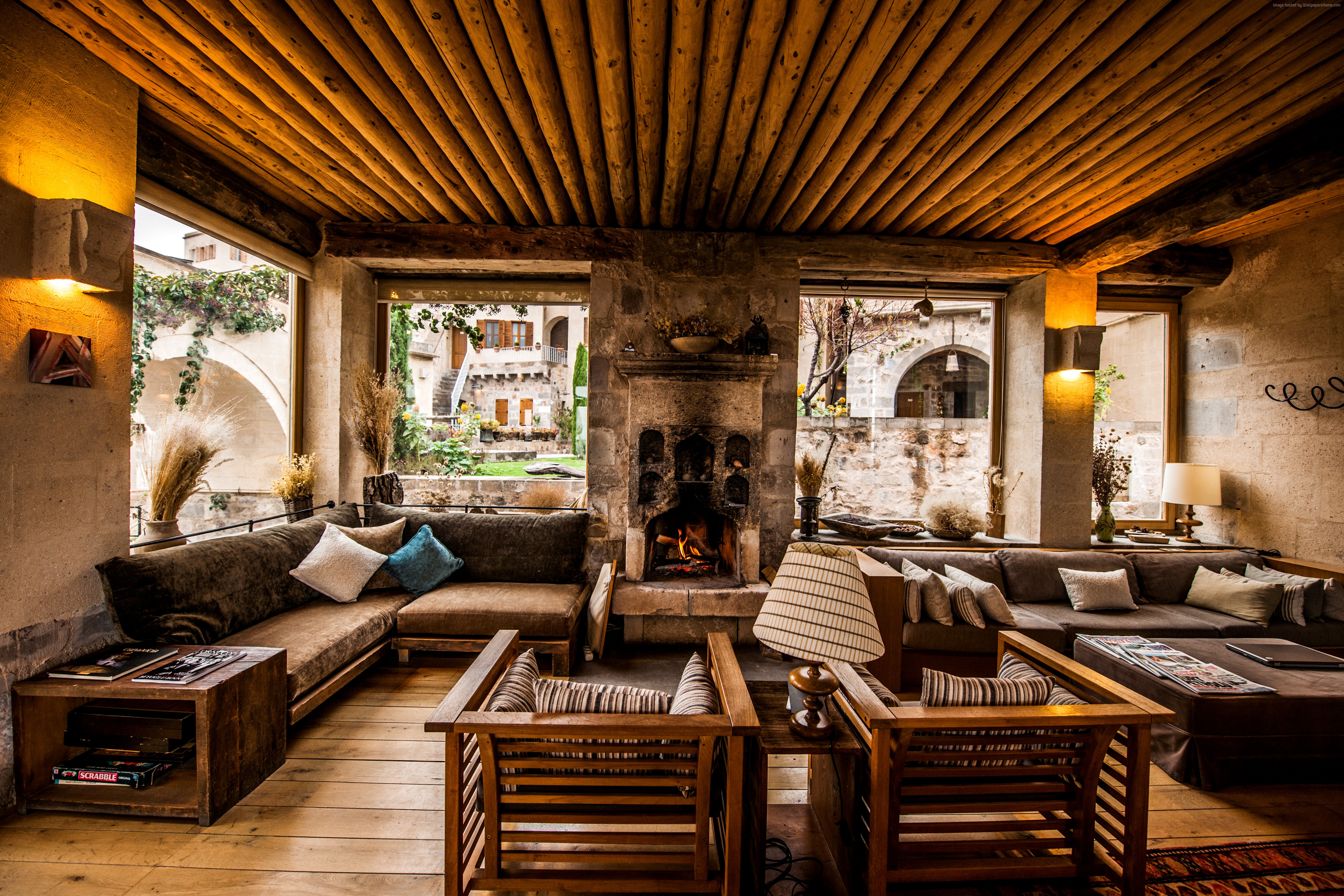 Cozy hotel lobby with fireplace and outdoor view in Turkey HD Wallpaper