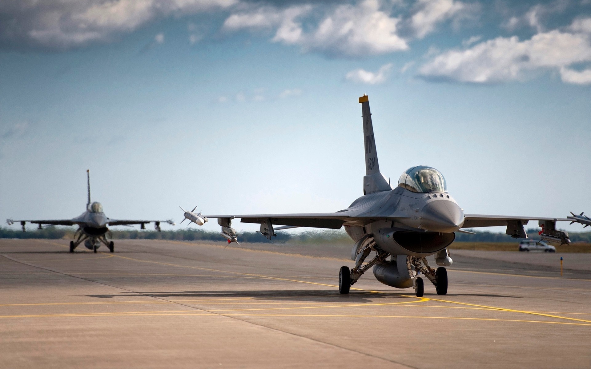 Two F-16 fighter jets on a runway HD Wallpaper