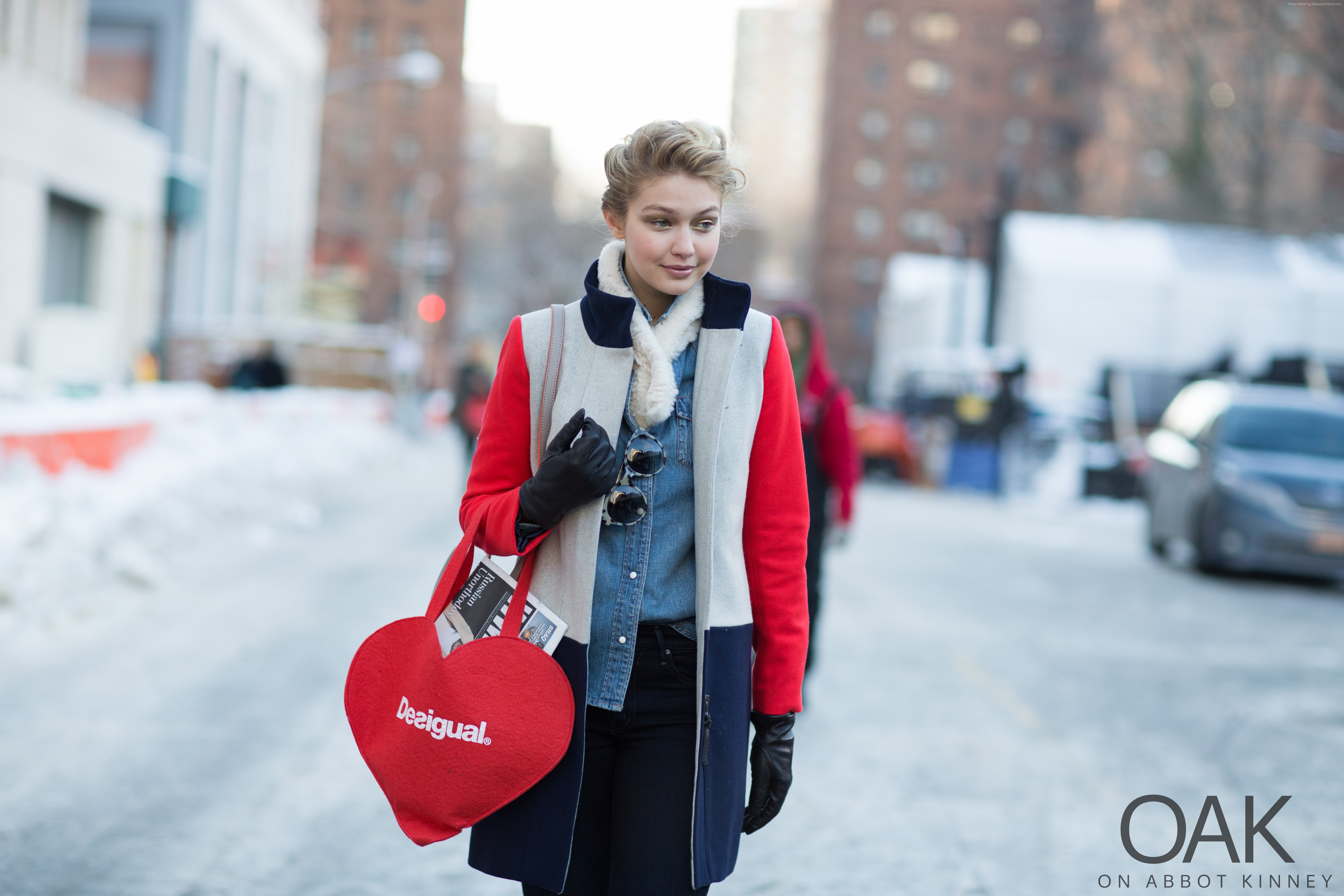 Gigi Hadid wearing a color-block coat and carrying a heart bag HD Wallpaper