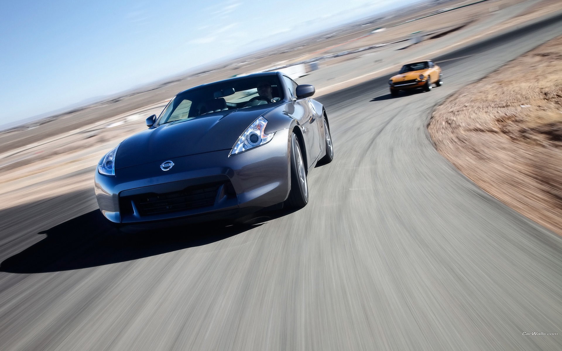 Nissan 370Z and orange car on a race track HD Wallpaper