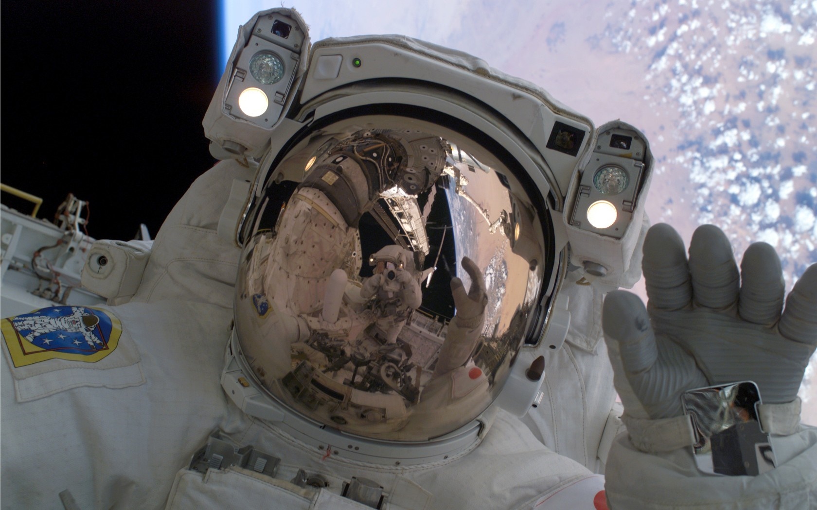 Astronaut in a spacesuit with Earth in the background HD Wallpaper