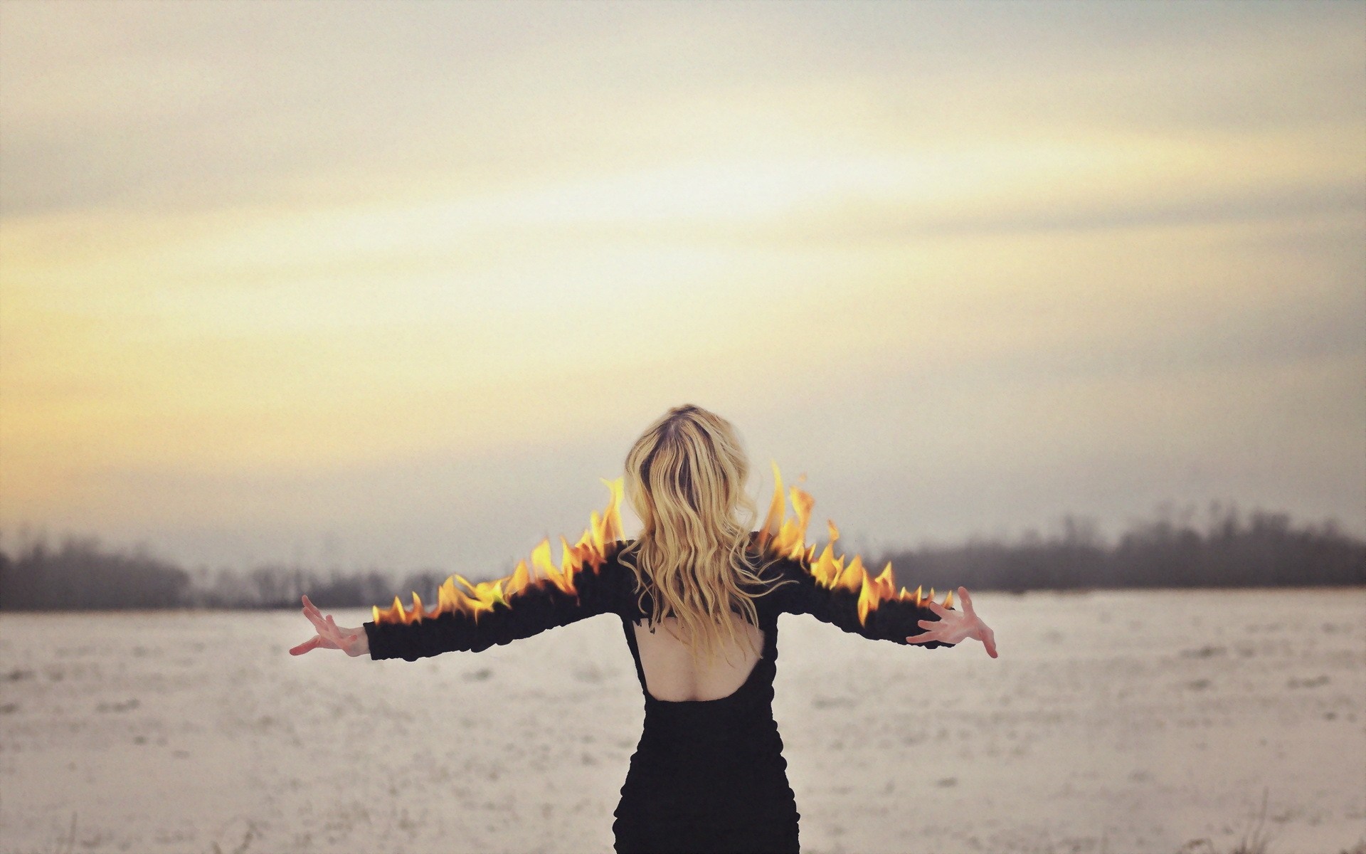 Woman with fire on arms at sunset HD Wallpaper