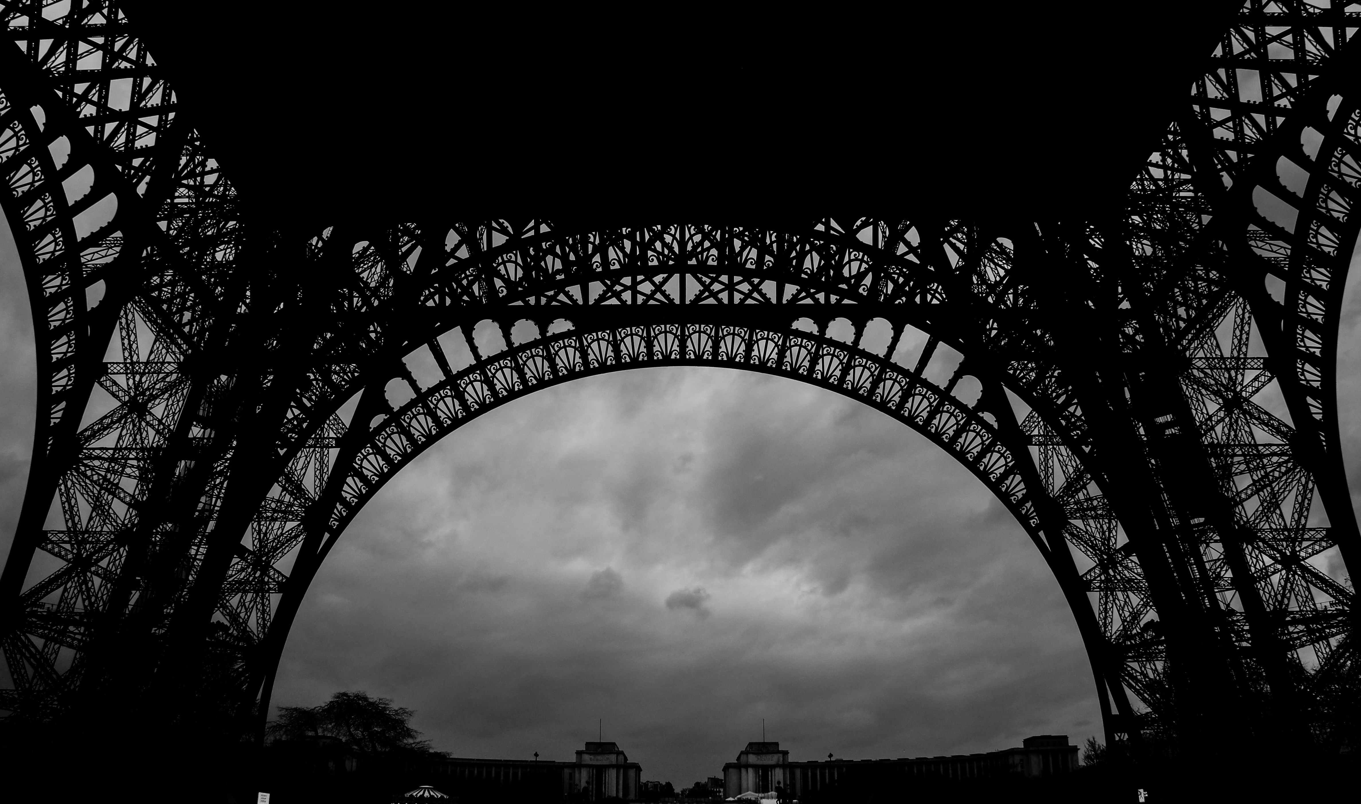 Eiffel Tower structure against a cloudy sky HD Wallpaper