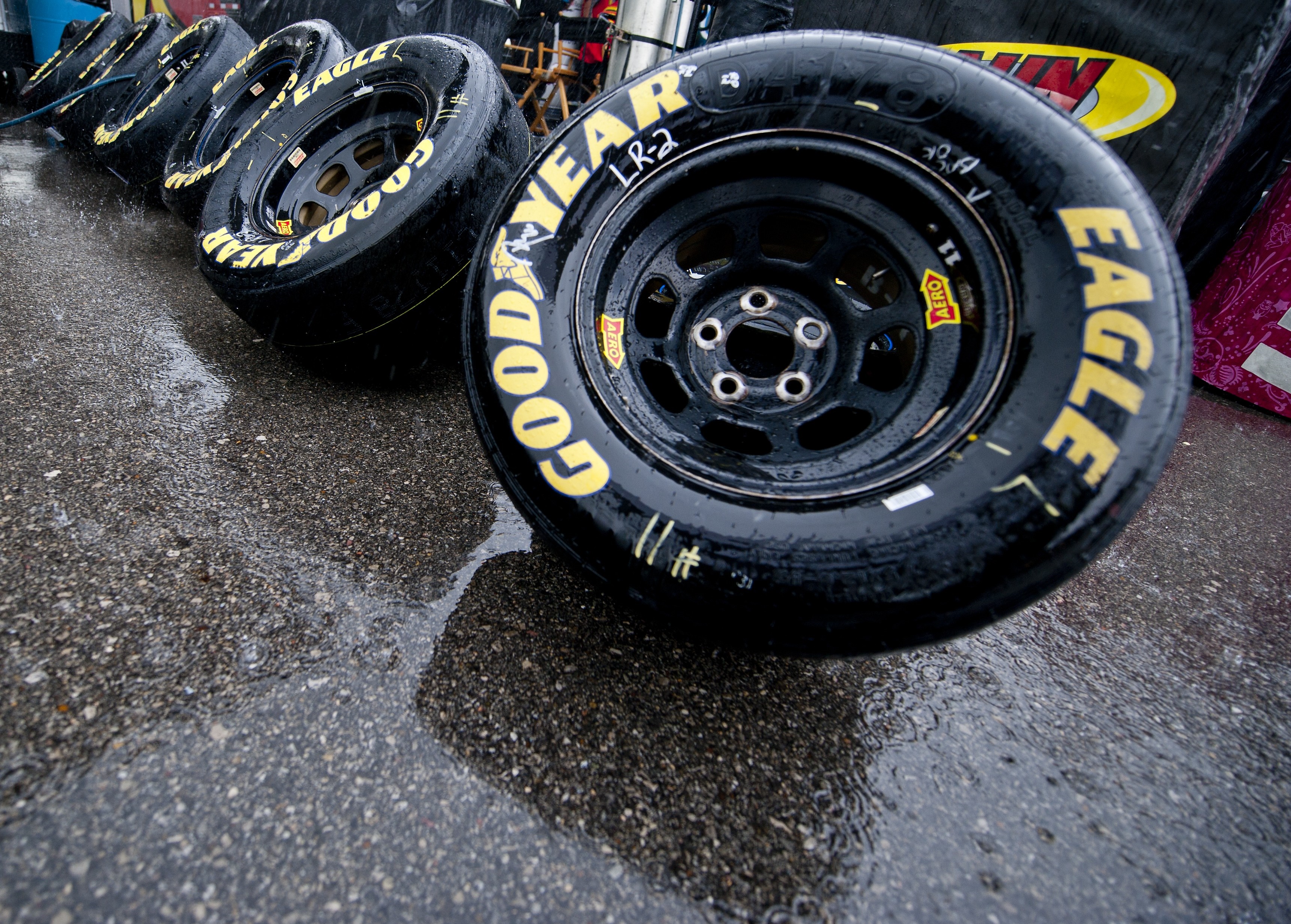 Goodyear Eagle racing tires on wet asphalt HD Wallpaper