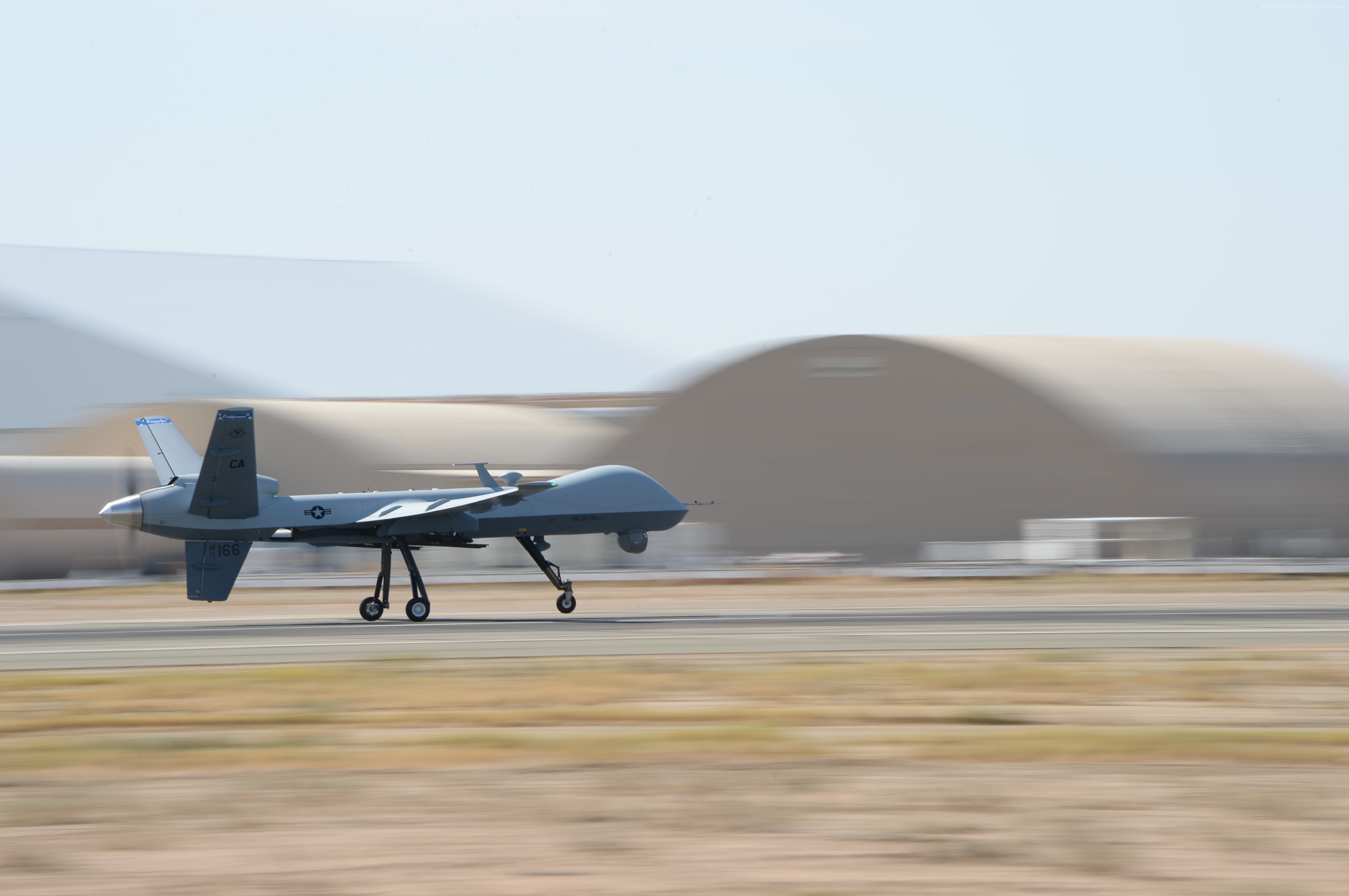 MQ-9 Reaper drone landing on a runway HD Wallpaper