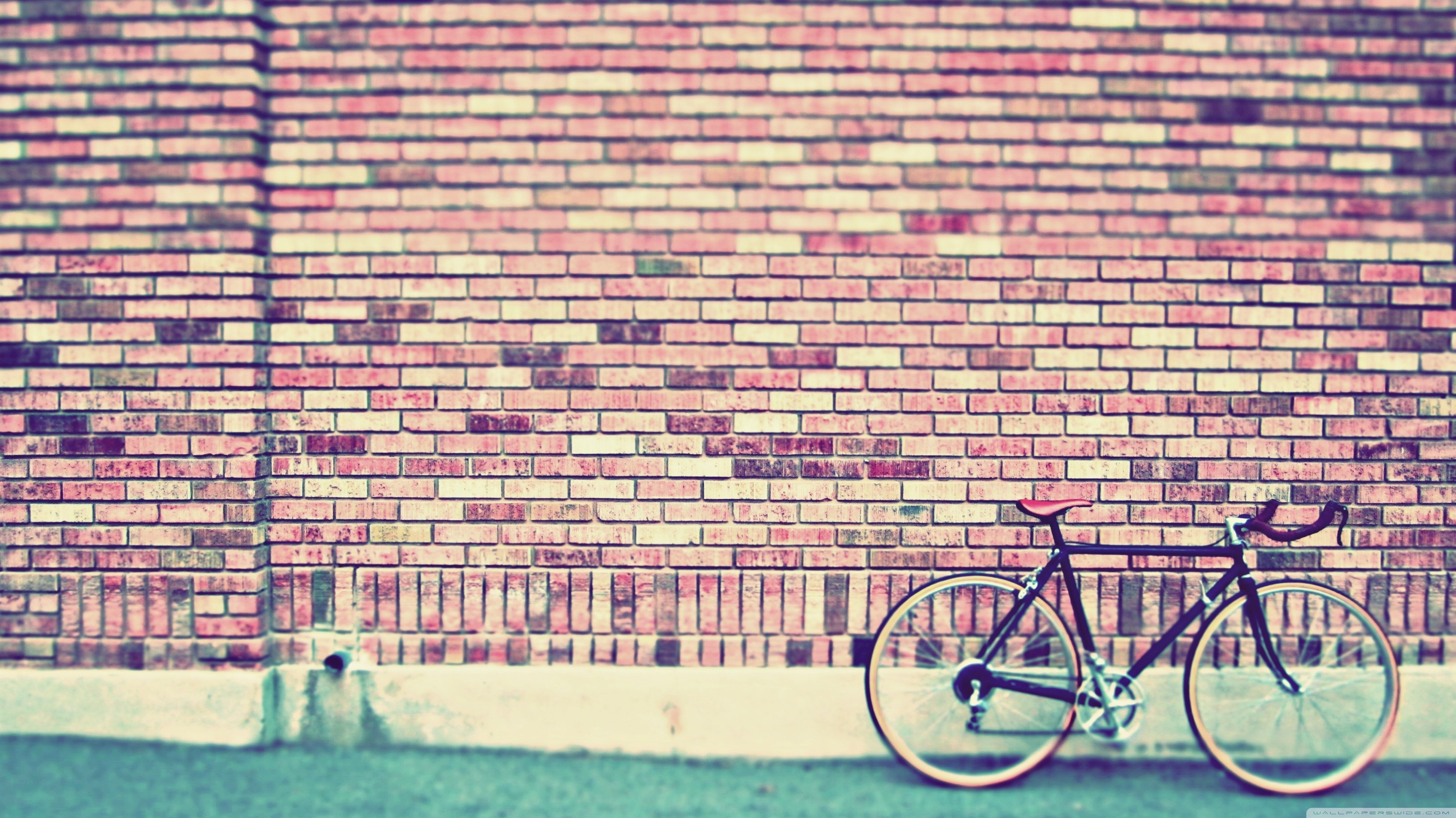 Bicycle leaning against a brick wall HD Wallpaper