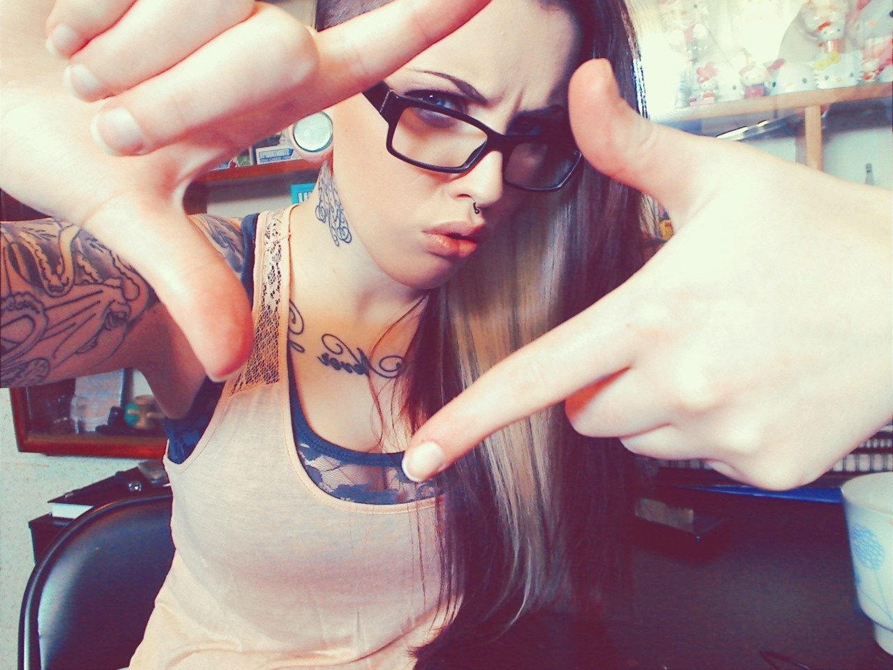 Woman with glasses and tattoos framing her face HD Wallpaper