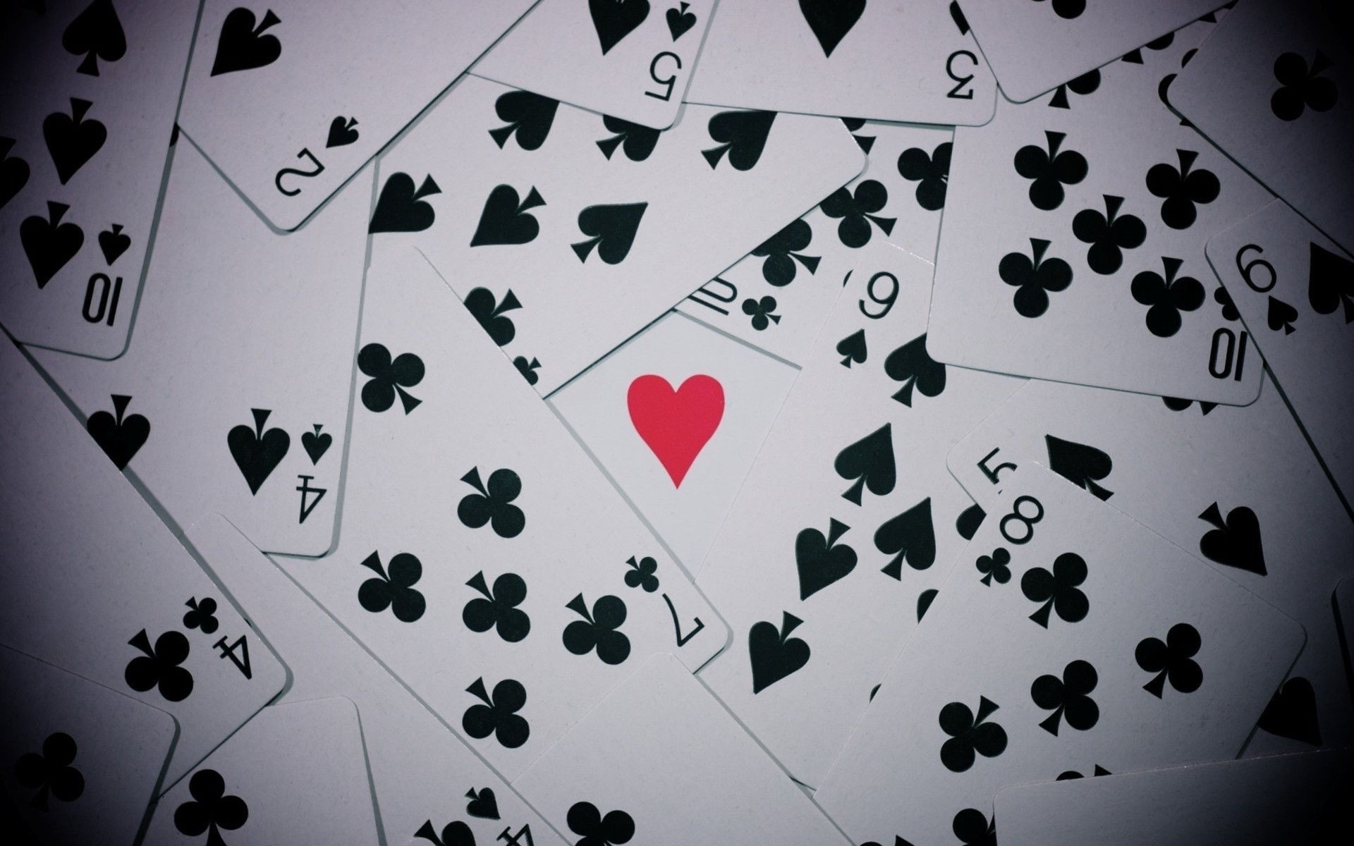 Scattered playing cards with suits and numbers HD Wallpaper