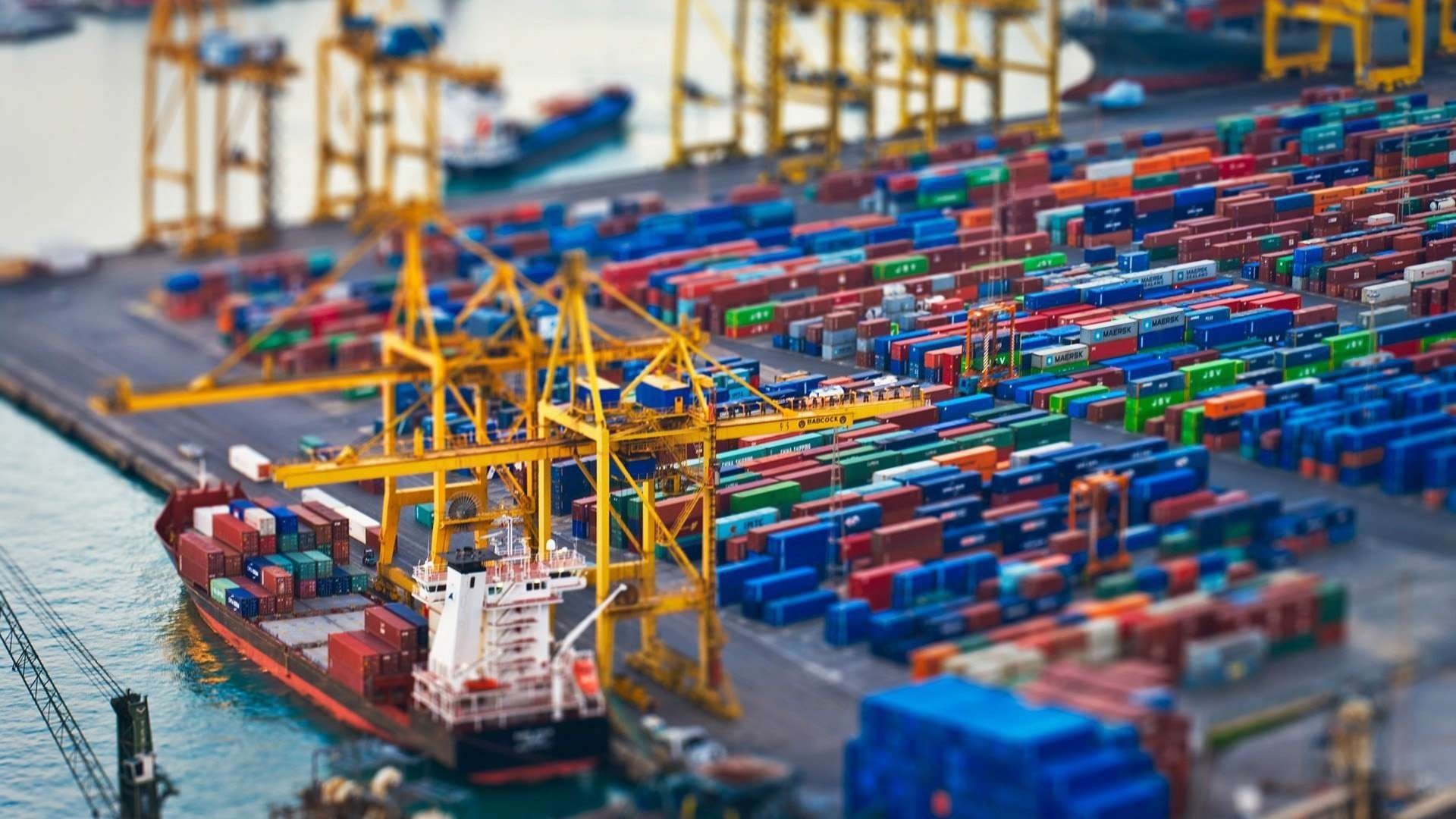 Container ship and cargo containers at a tilt-shift port HD Wallpaper