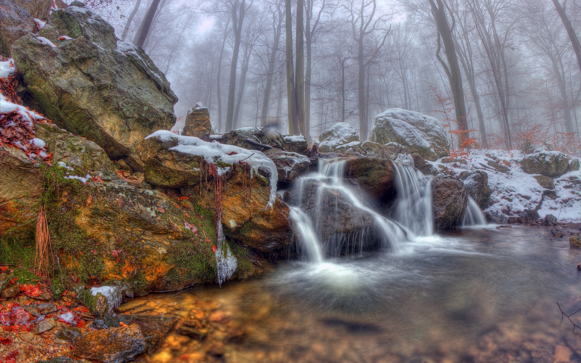 Misty forest waterfall with snow and rocks HD Wallpaper