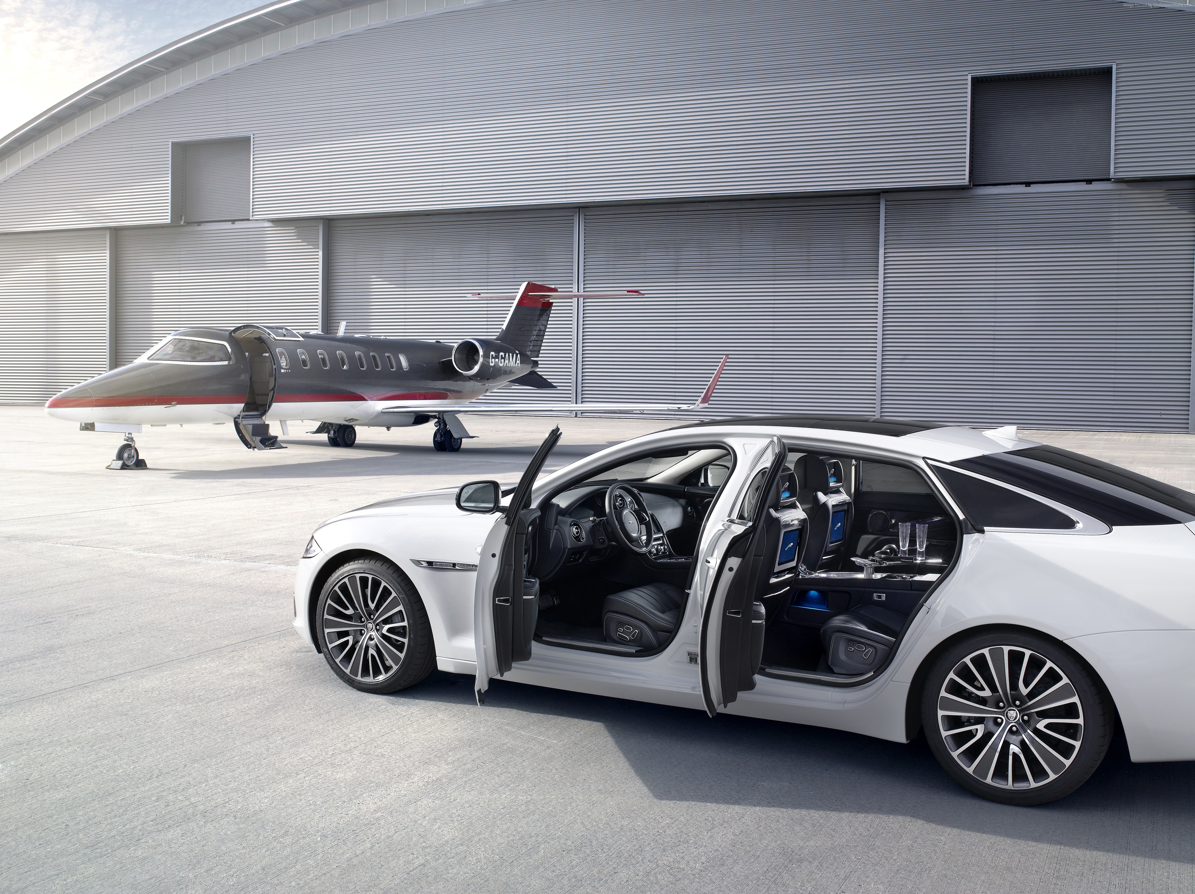 Jaguar XJ and private jet parked at hangar HD Wallpaper