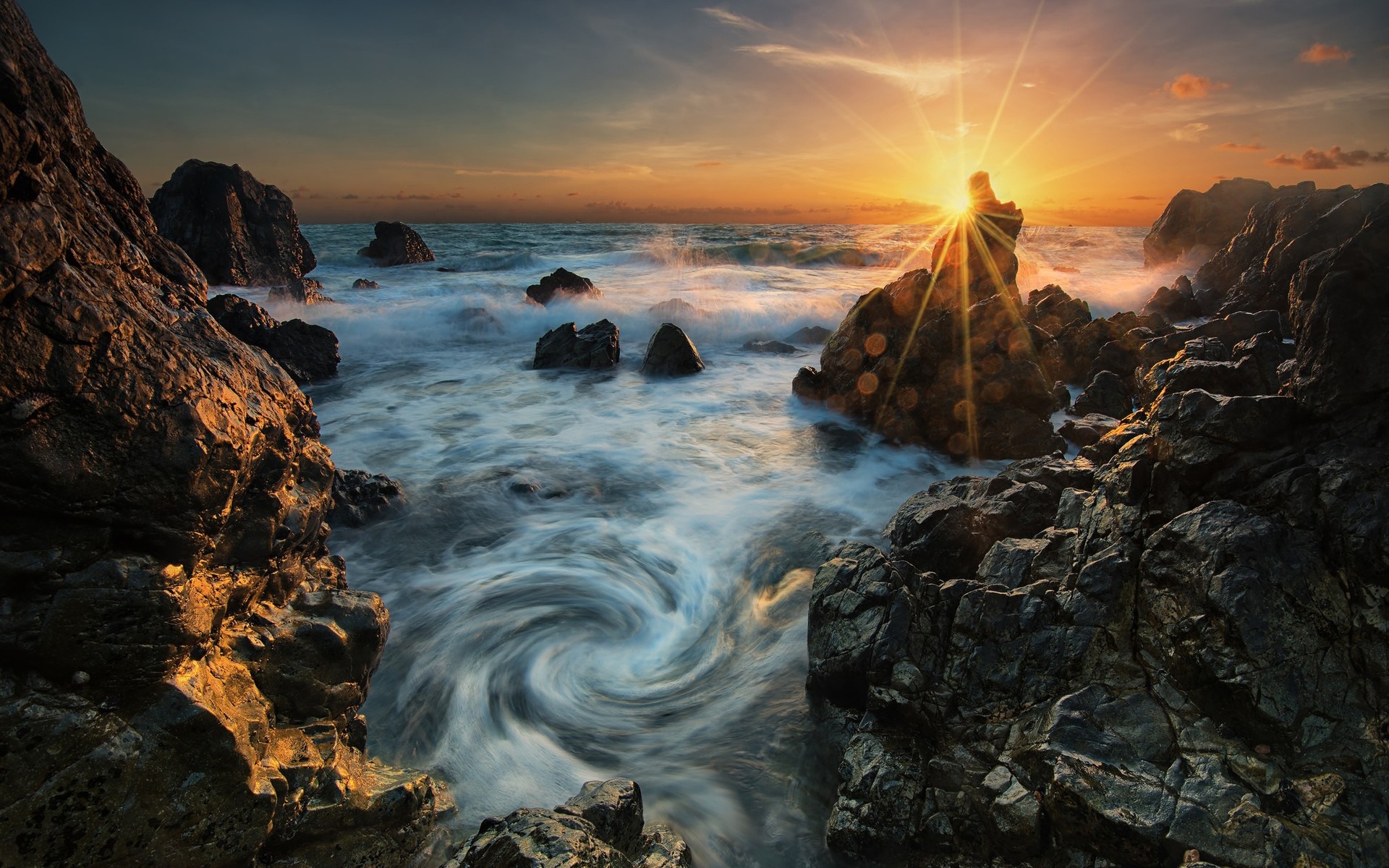 Sunset over rocky coast with swirling ocean waves HD Wallpaper