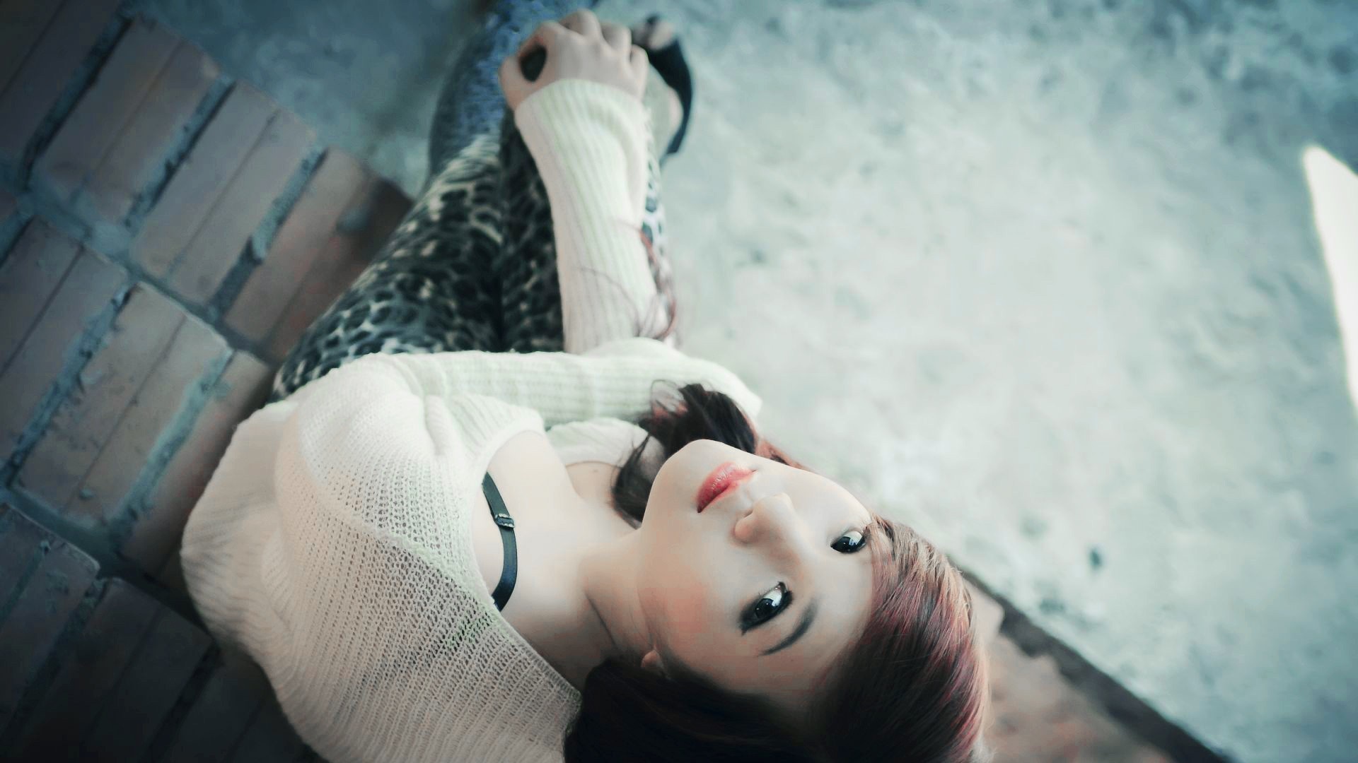 Asian woman lying down wearing a white sweater HD Wallpaper