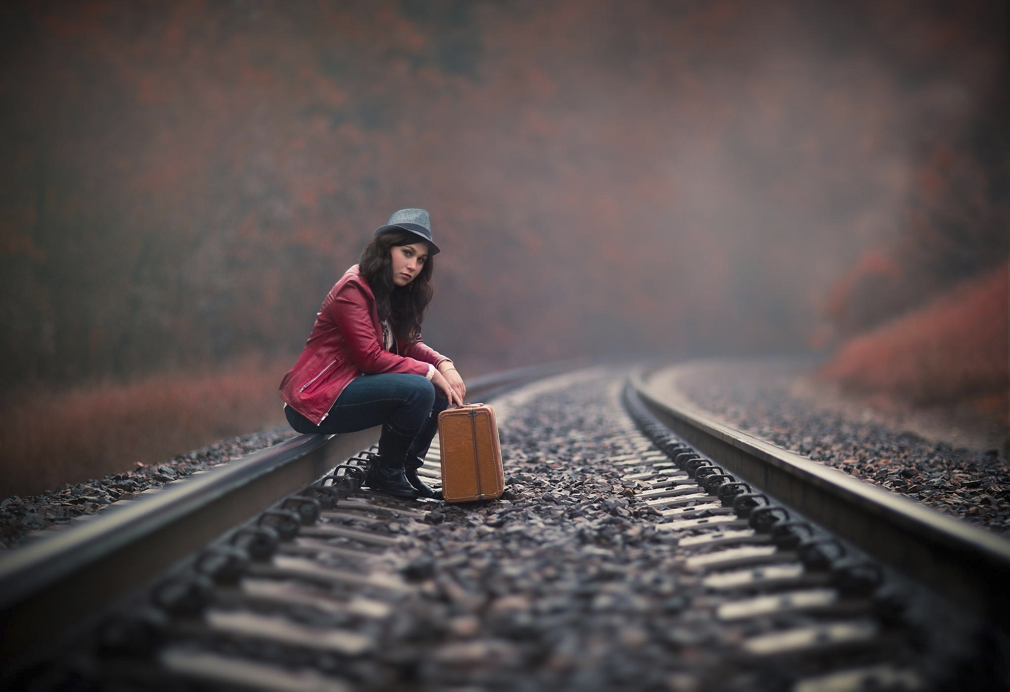 Woman with suitcase on train tracks HD Wallpaper