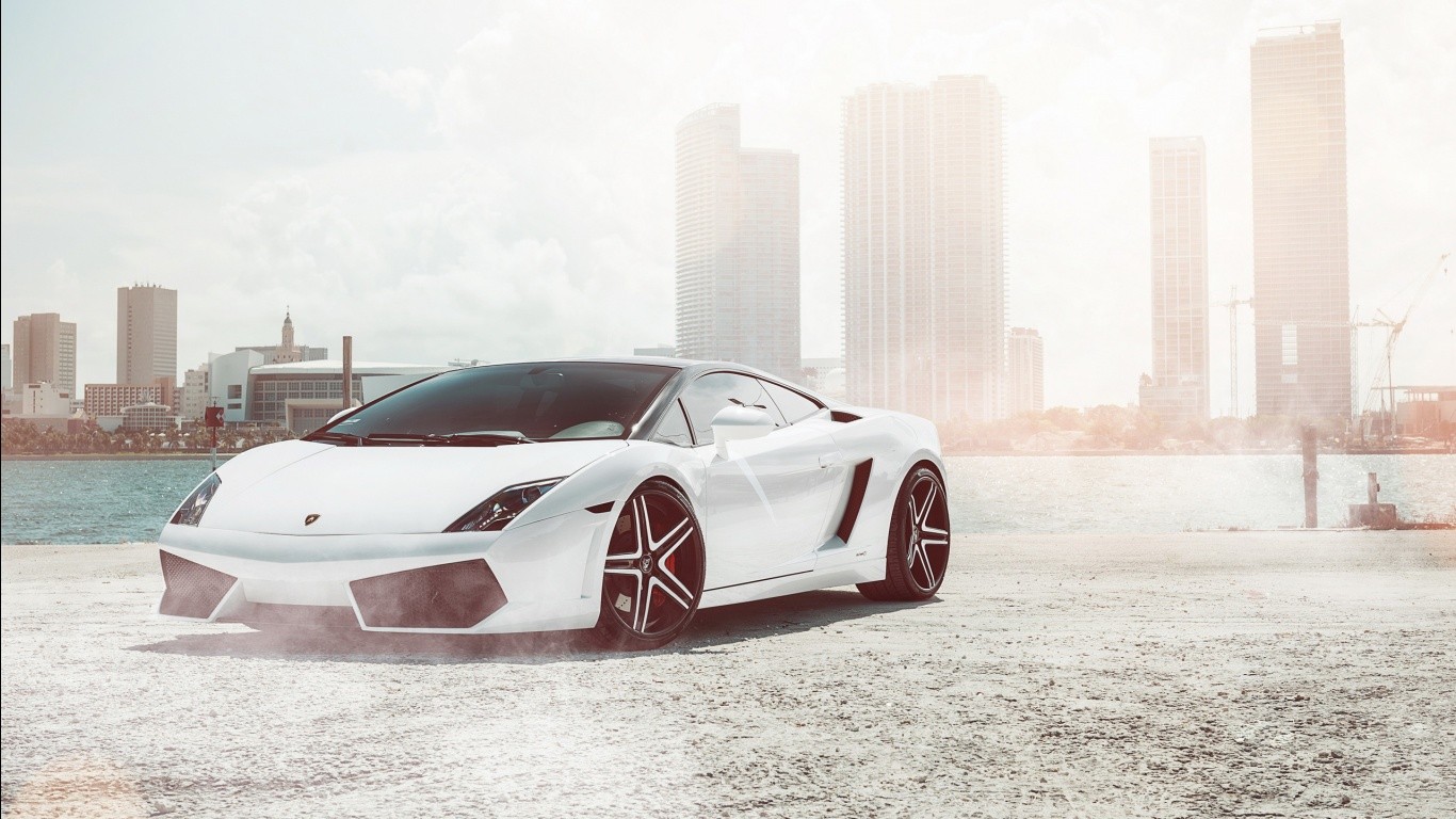 White Lamborghini Gallardo parked by the water with city skyline HD Wallpaper