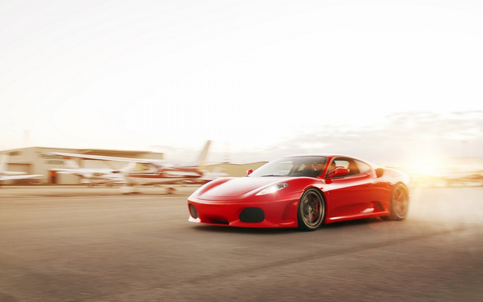 Red Ferrari F430 driving on an airfield HD Wallpaper