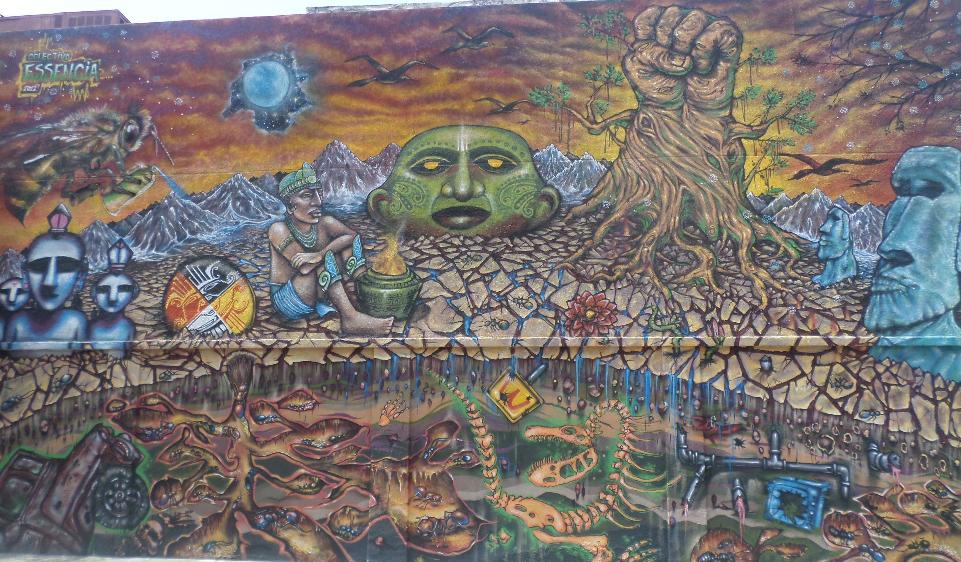 Mural with indigenous figures, giant green head, and Easter Island statues HD Wallpaper
