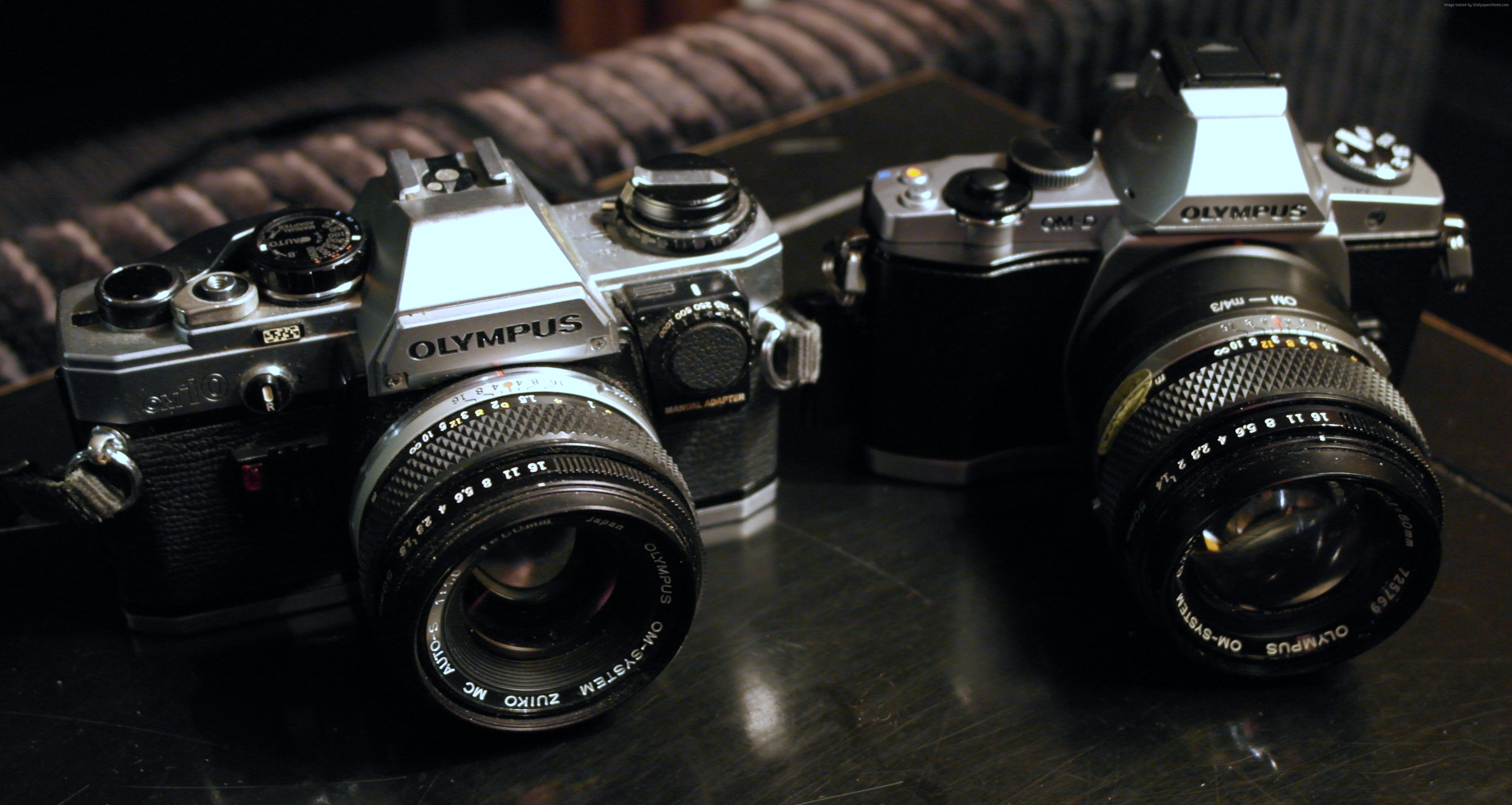Two Olympus OM-System cameras with lenses HD Wallpaper