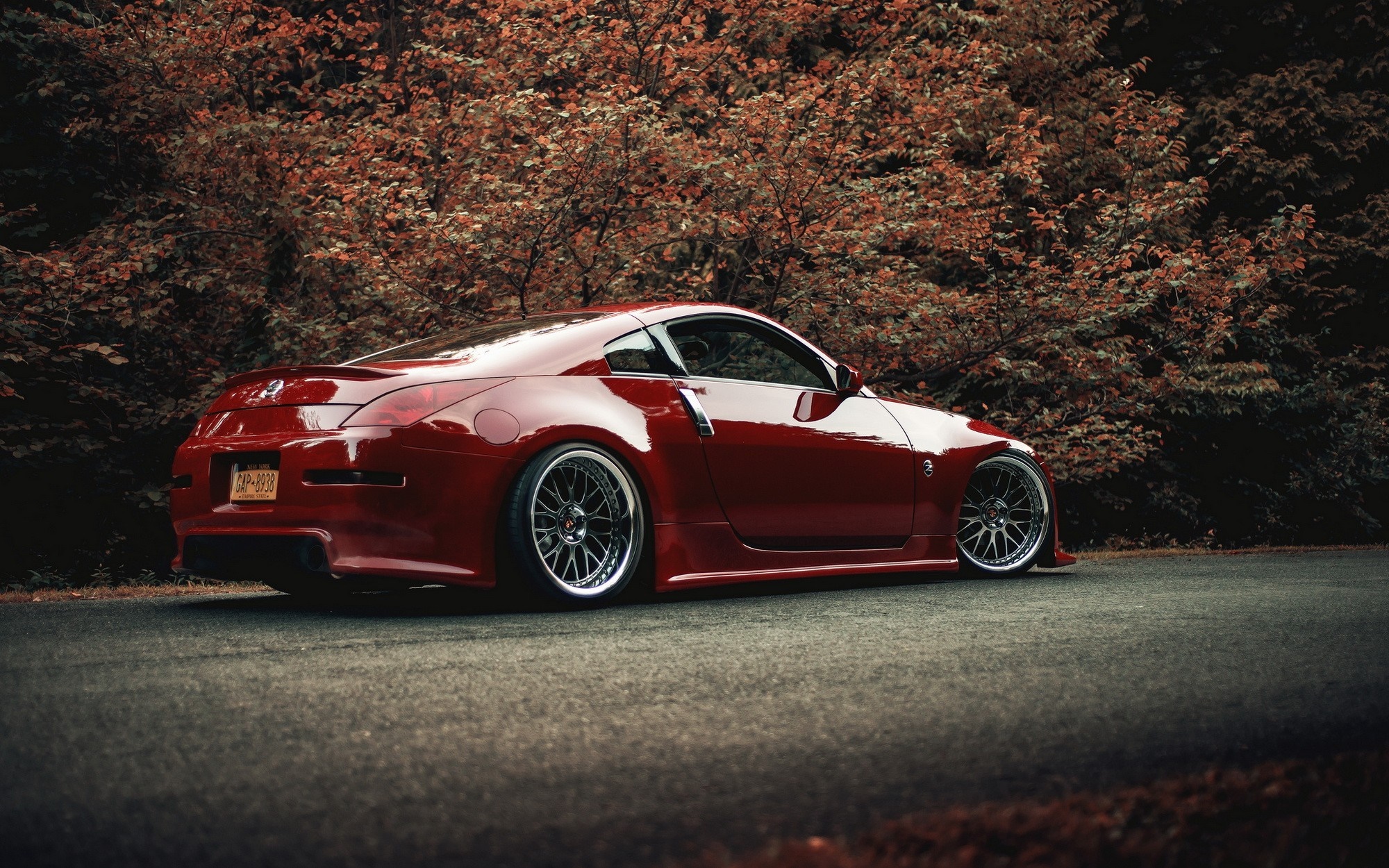 Red Nissan 350Z sports car on a road HD Wallpaper