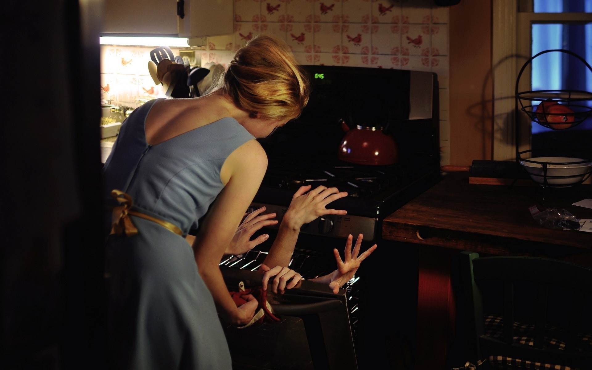Woman reaching into oven with multiple hands HD Wallpaper