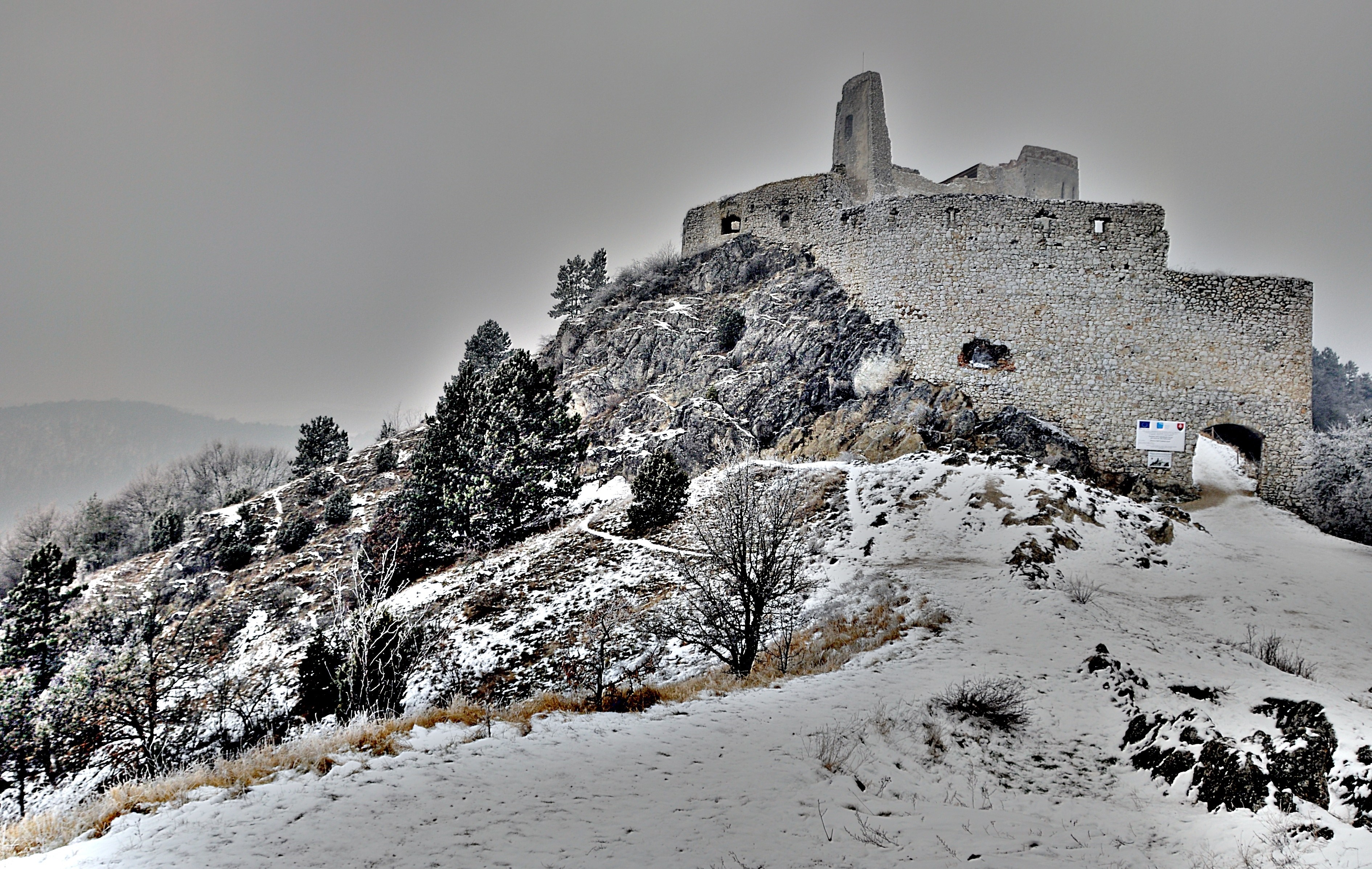 Castle ruins on a snowy hill in Slovakia HD Wallpaper