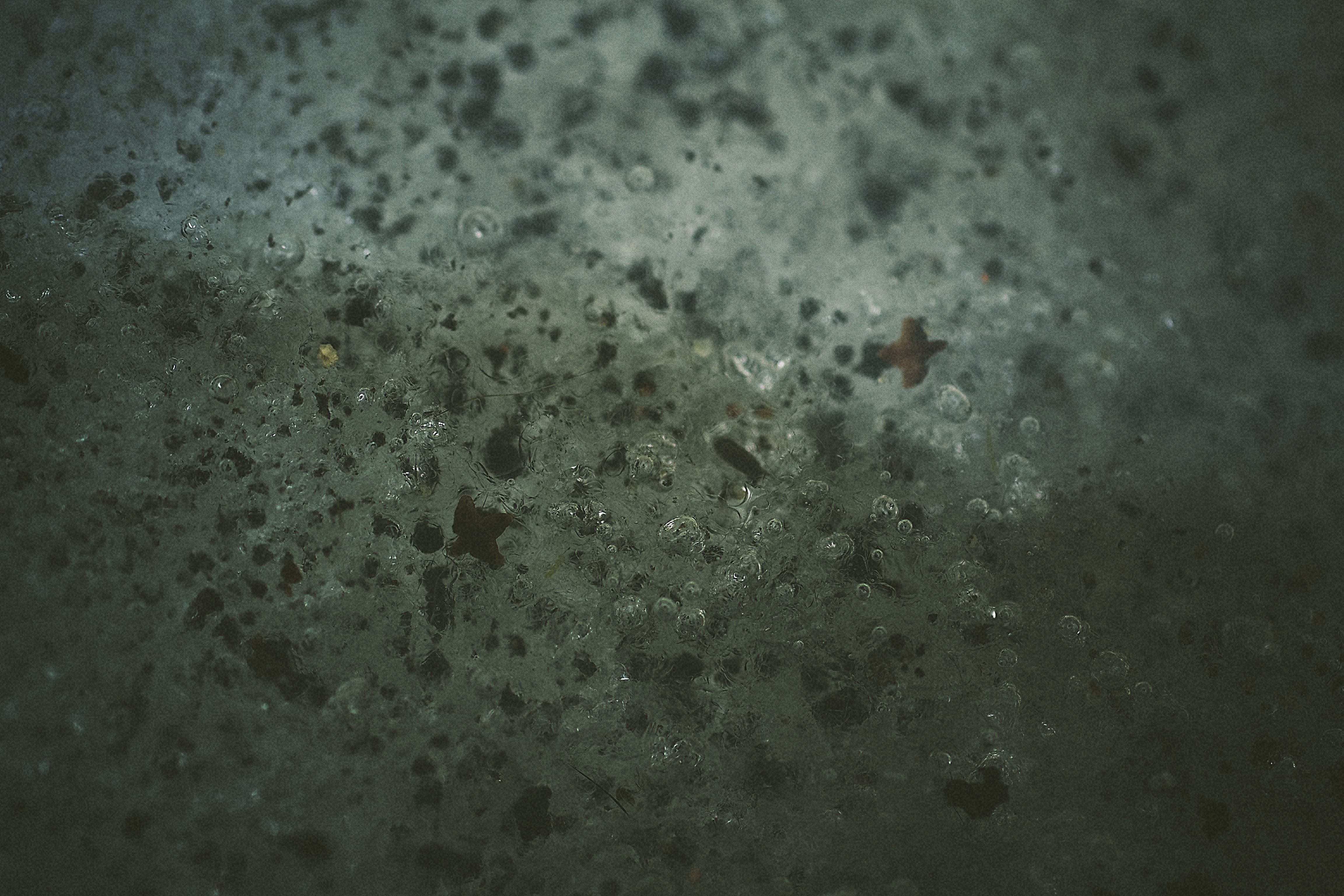 Macro photography of ice texture with bubbles and dark particles HD Wallpaper