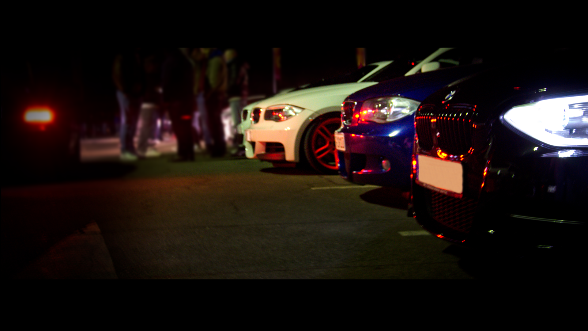 BMW sports cars parked at night with people HD Wallpaper