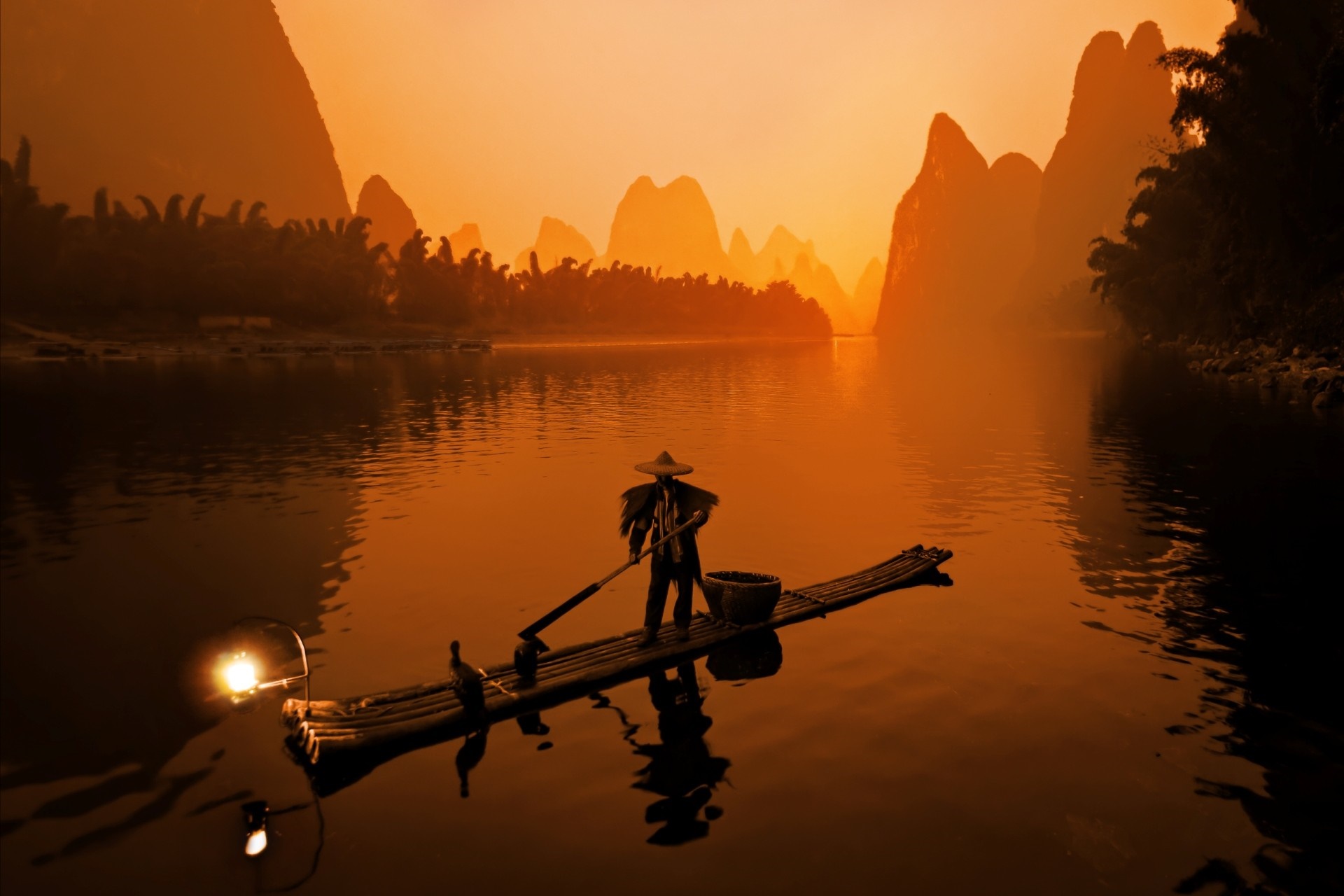 Fisherman on a raft on the Li River at sunset HD Wallpaper