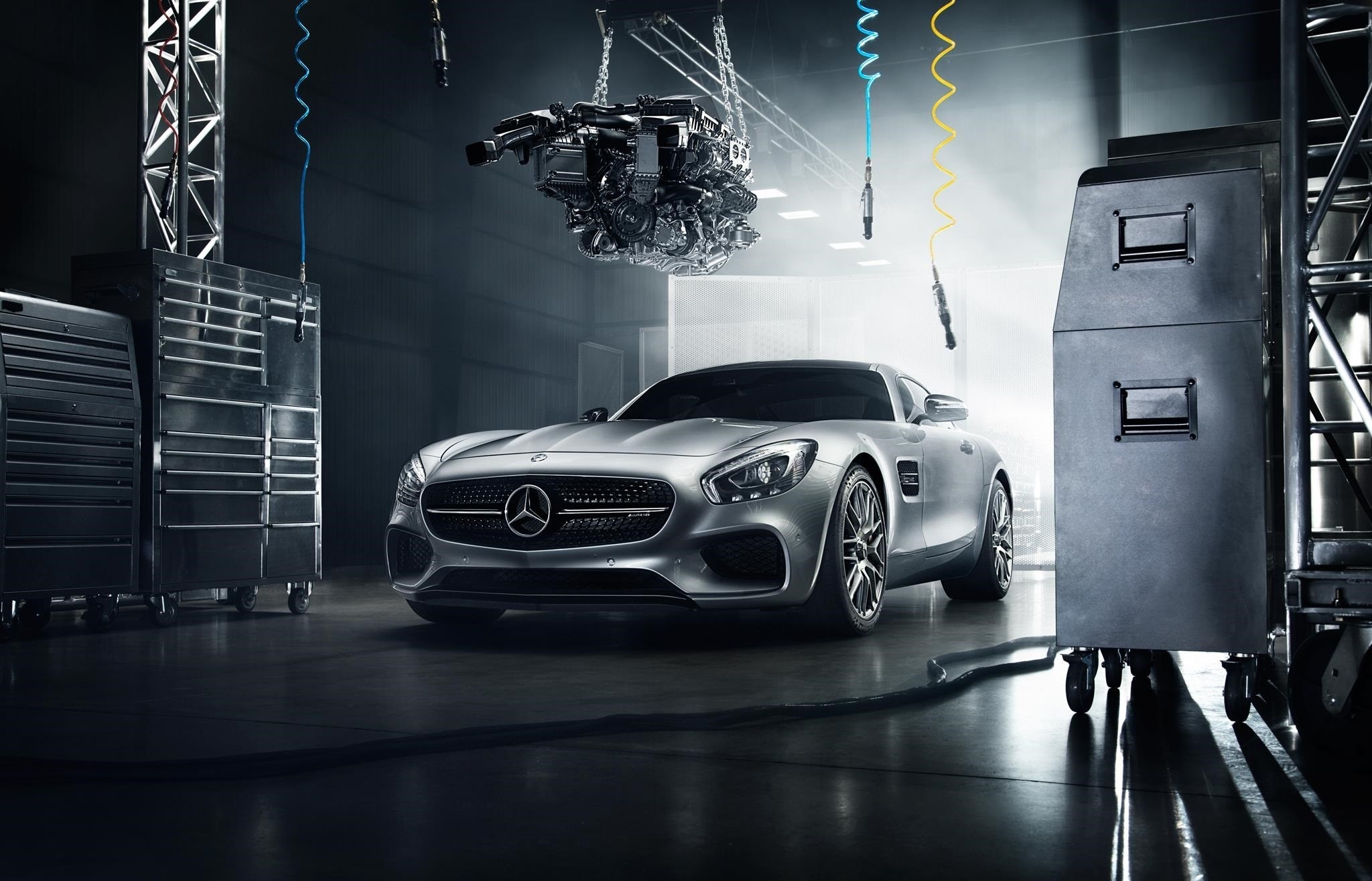 Silver Mercedes-Benz sports car in a workshop with engine overhead HD Wallpaper