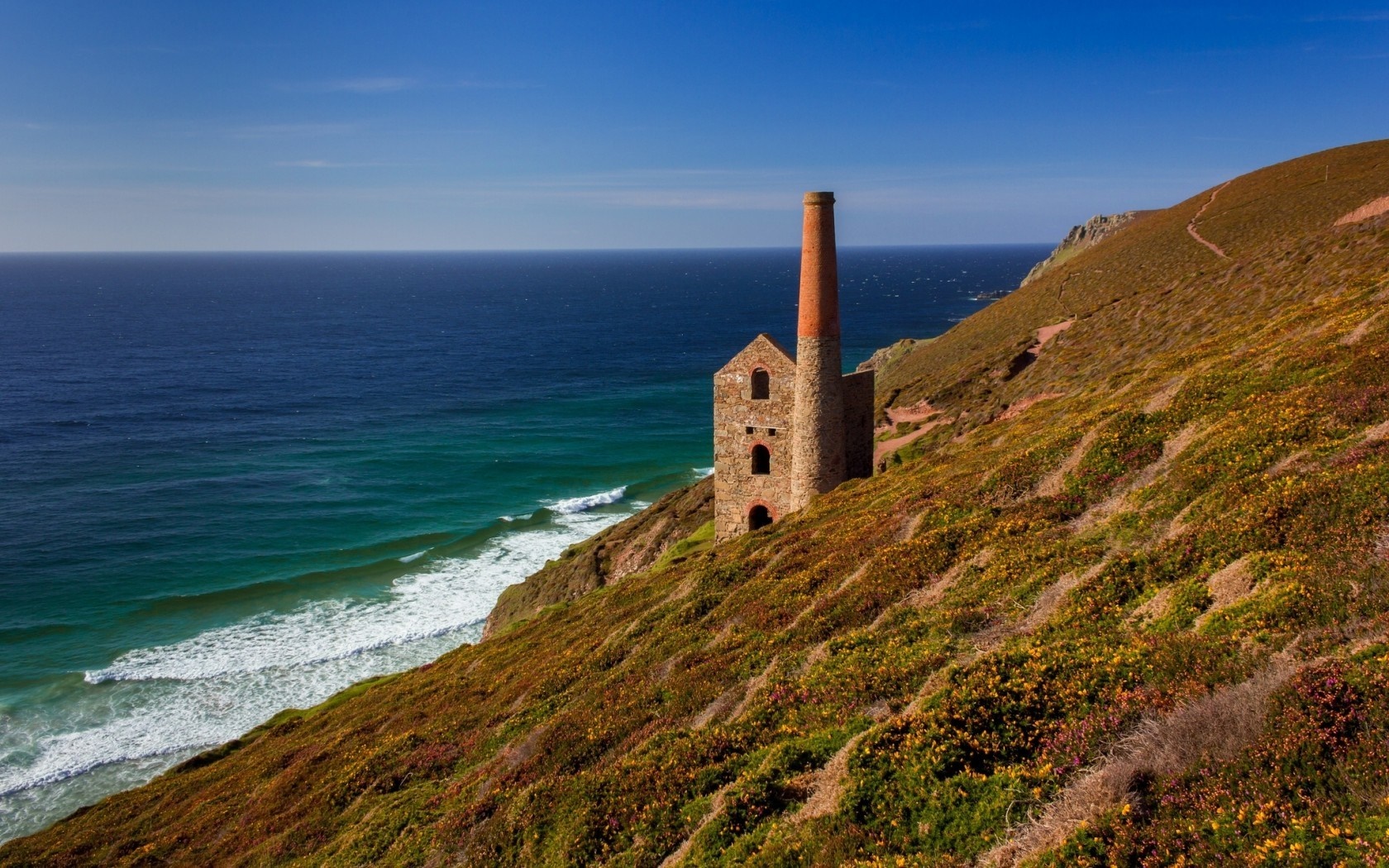 Old mining building on a cliff overlooking the sea in Cornwall, UK HD Wallpaper
