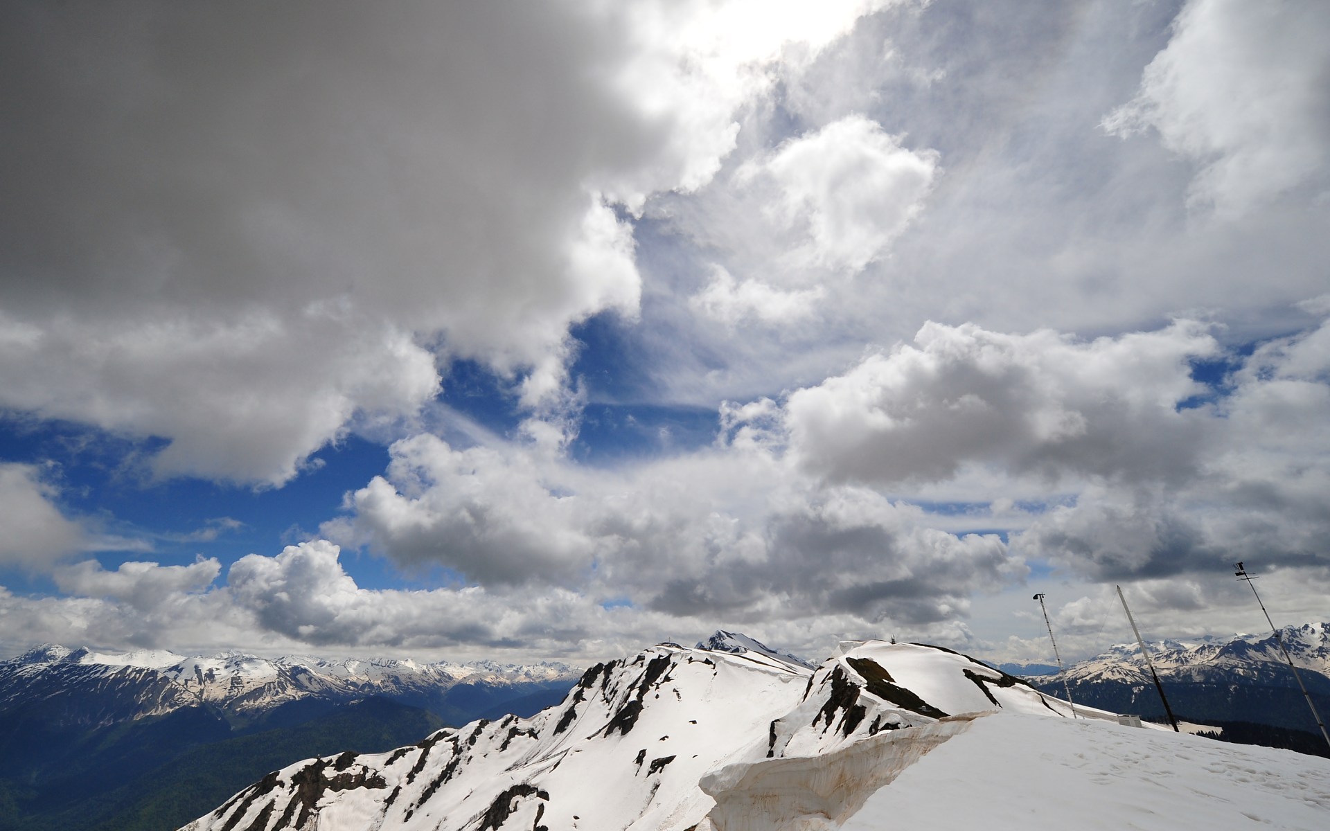 Snowy mountain peaks under a cloudy sky HD Wallpaper