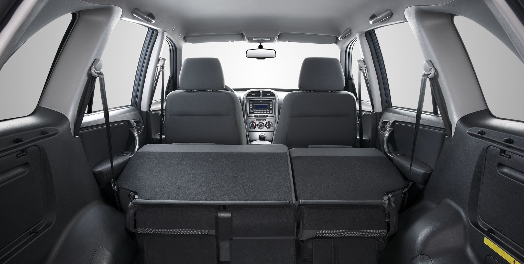 Interior of a car with folded rear seats HD Wallpaper