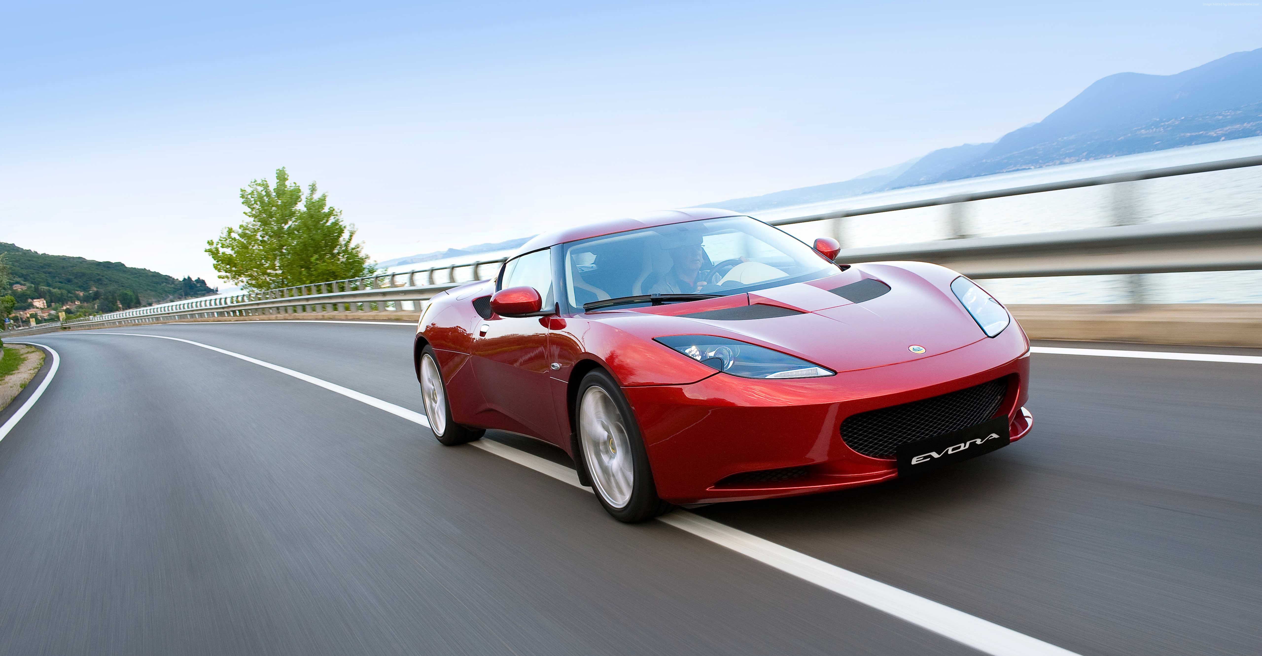 Red Lotus Evora S sports car driving on a road HD Wallpaper
